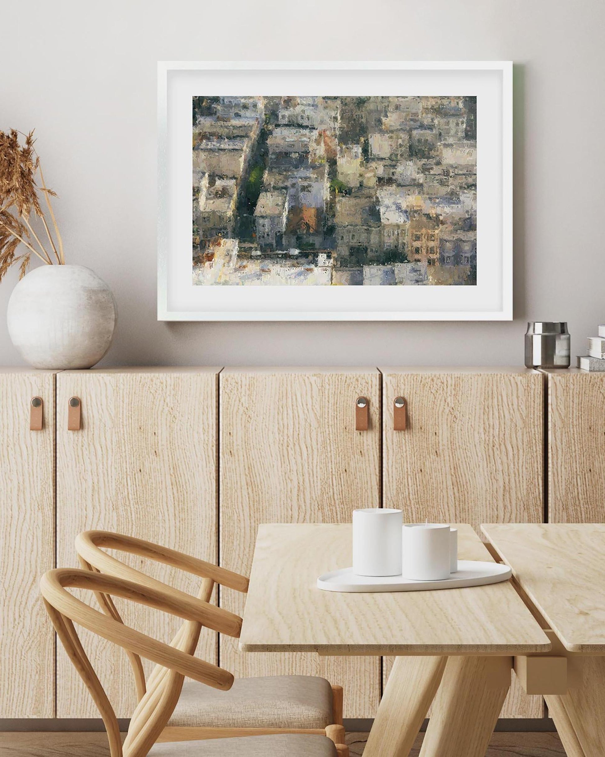 Dining room with wooden furniture, a framed abstract painting on the wall, and a small table with cups.