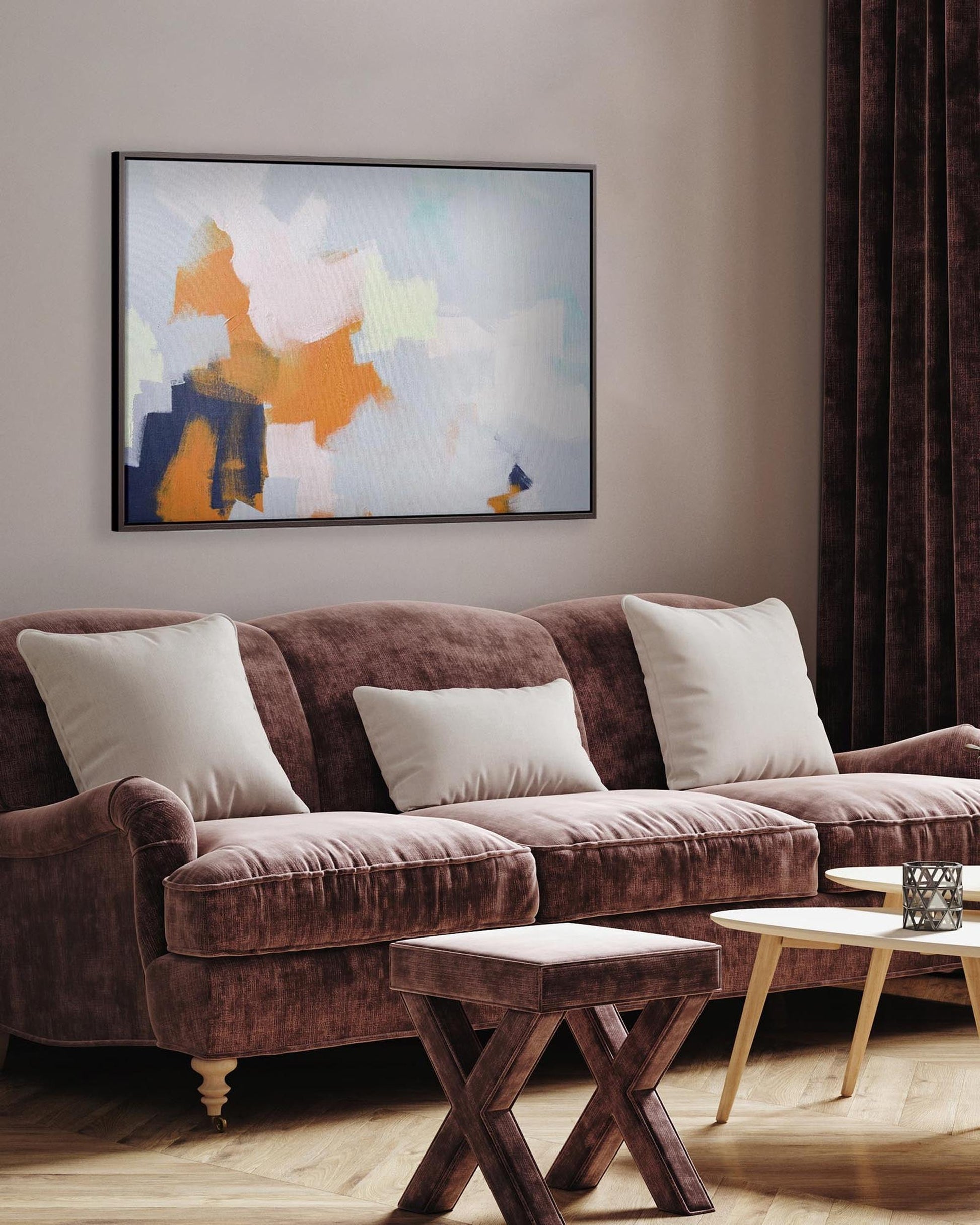 Living room with a brown sofa, wooden coffee table, and abstract art on the wall.