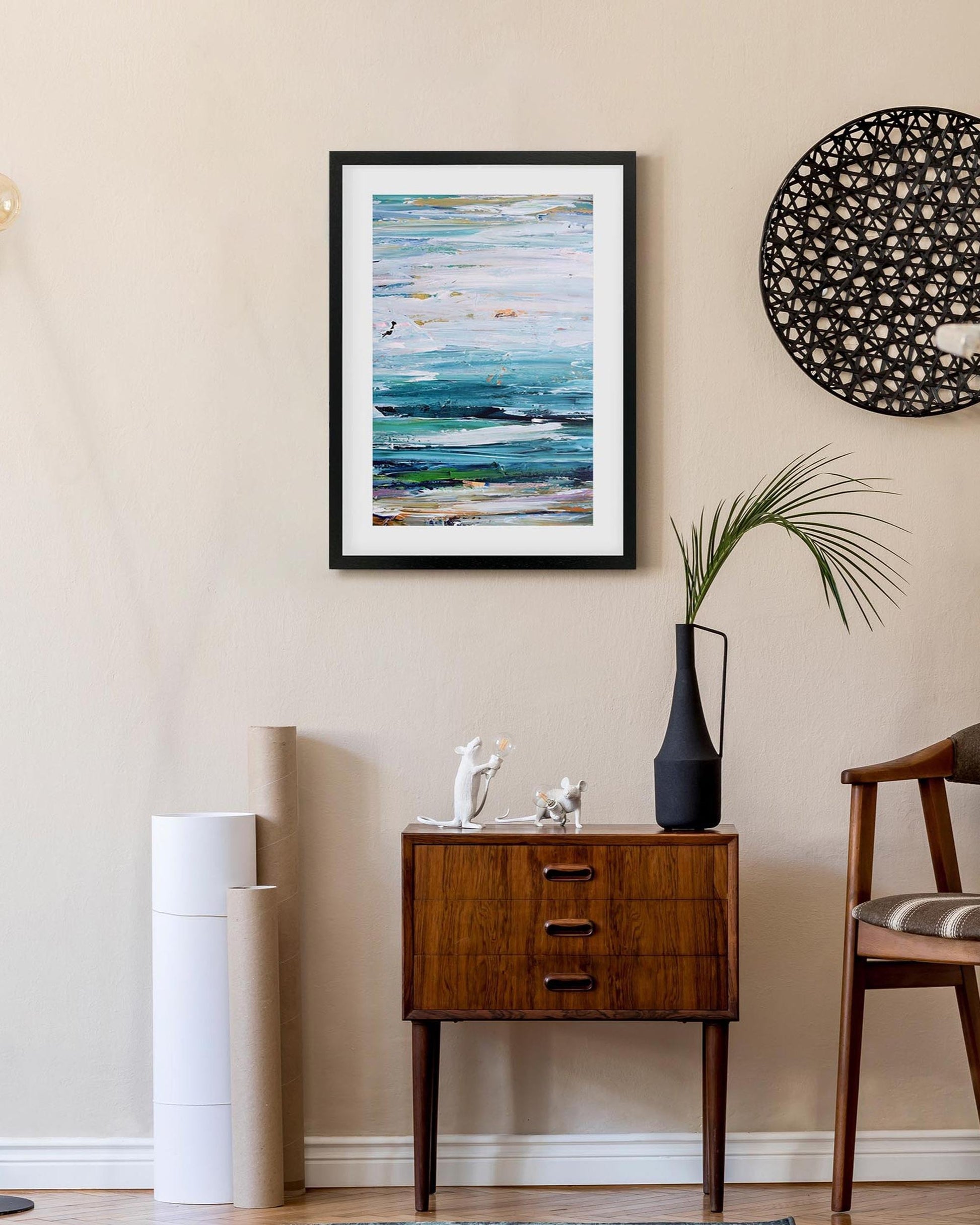 Living room interior with a wooden side table, abstract art, and decorative elements.