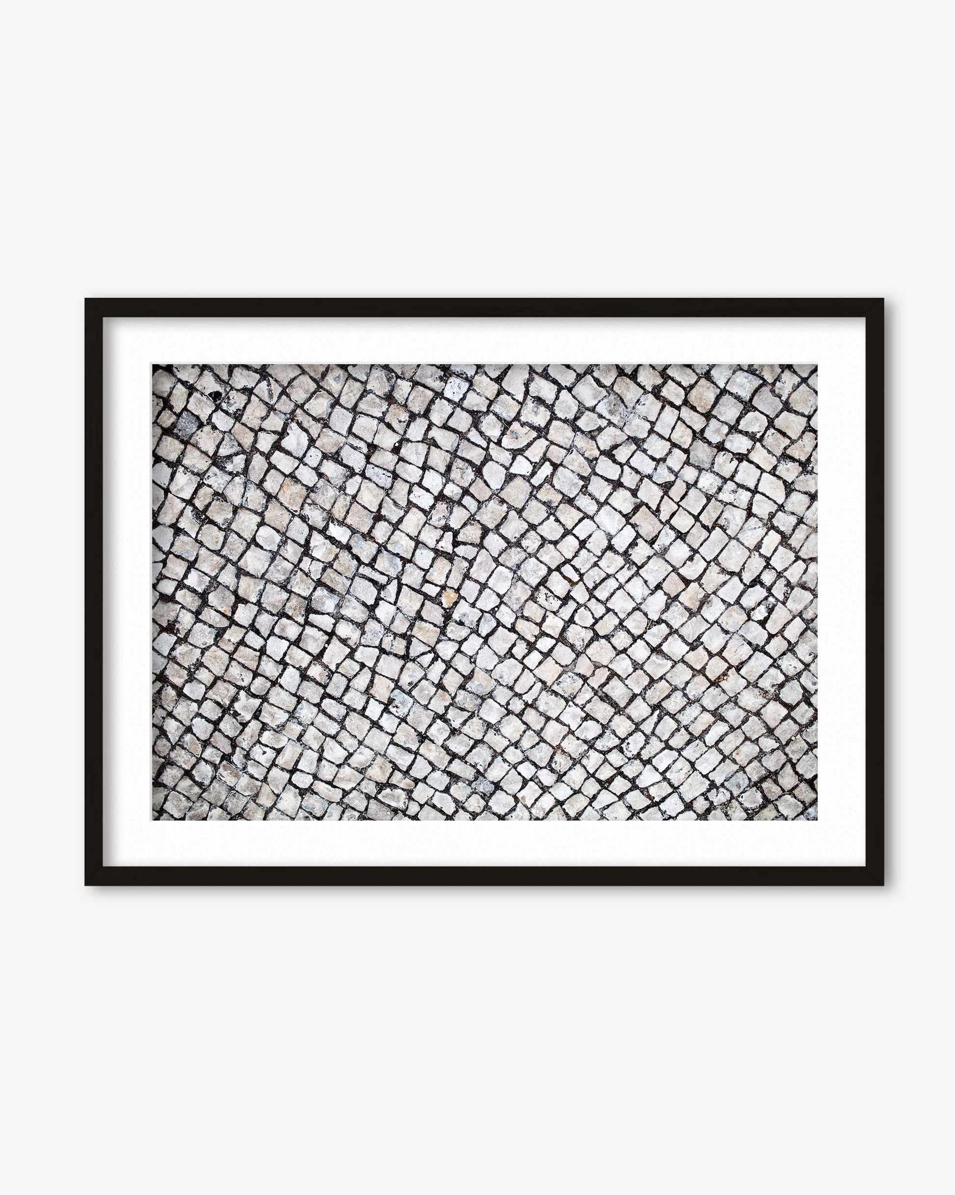 Framed black and white abstract art on a white wall