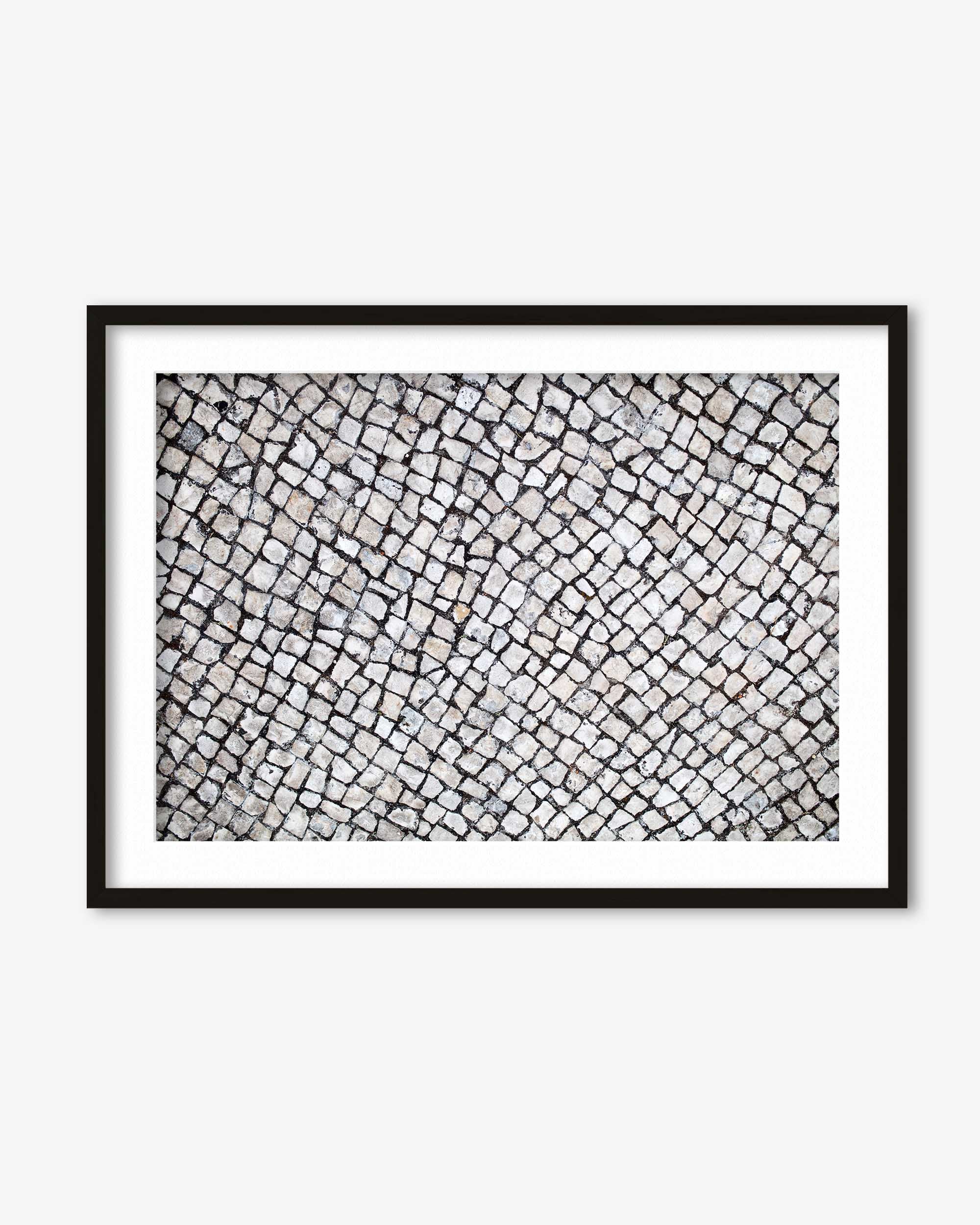Framed black and white abstract art on a white wall