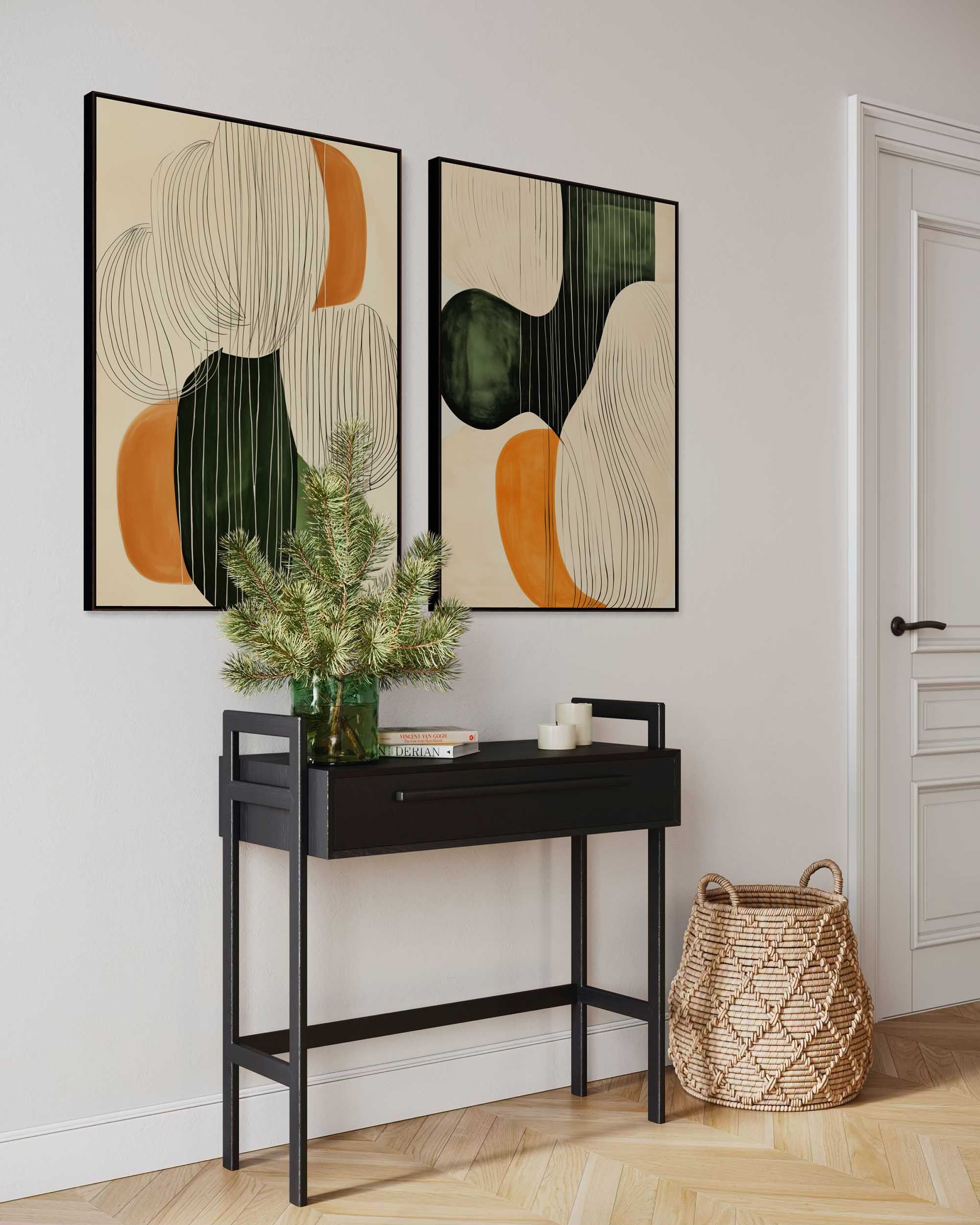 Two abstract art pieces on a wall above a black console table with decorative items.
