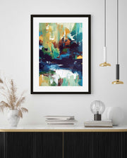 Framed abstract art piece on a wall above a console table with decorative items.