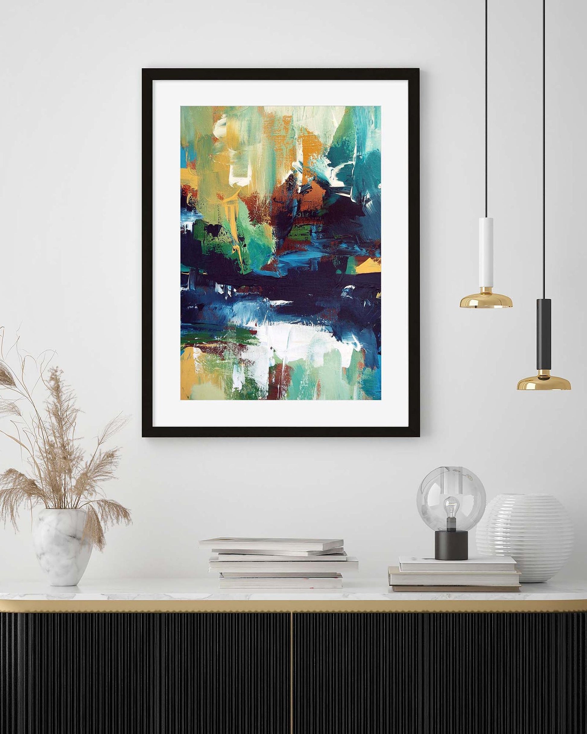 Framed abstract art piece on a wall above a console table with decorative items.