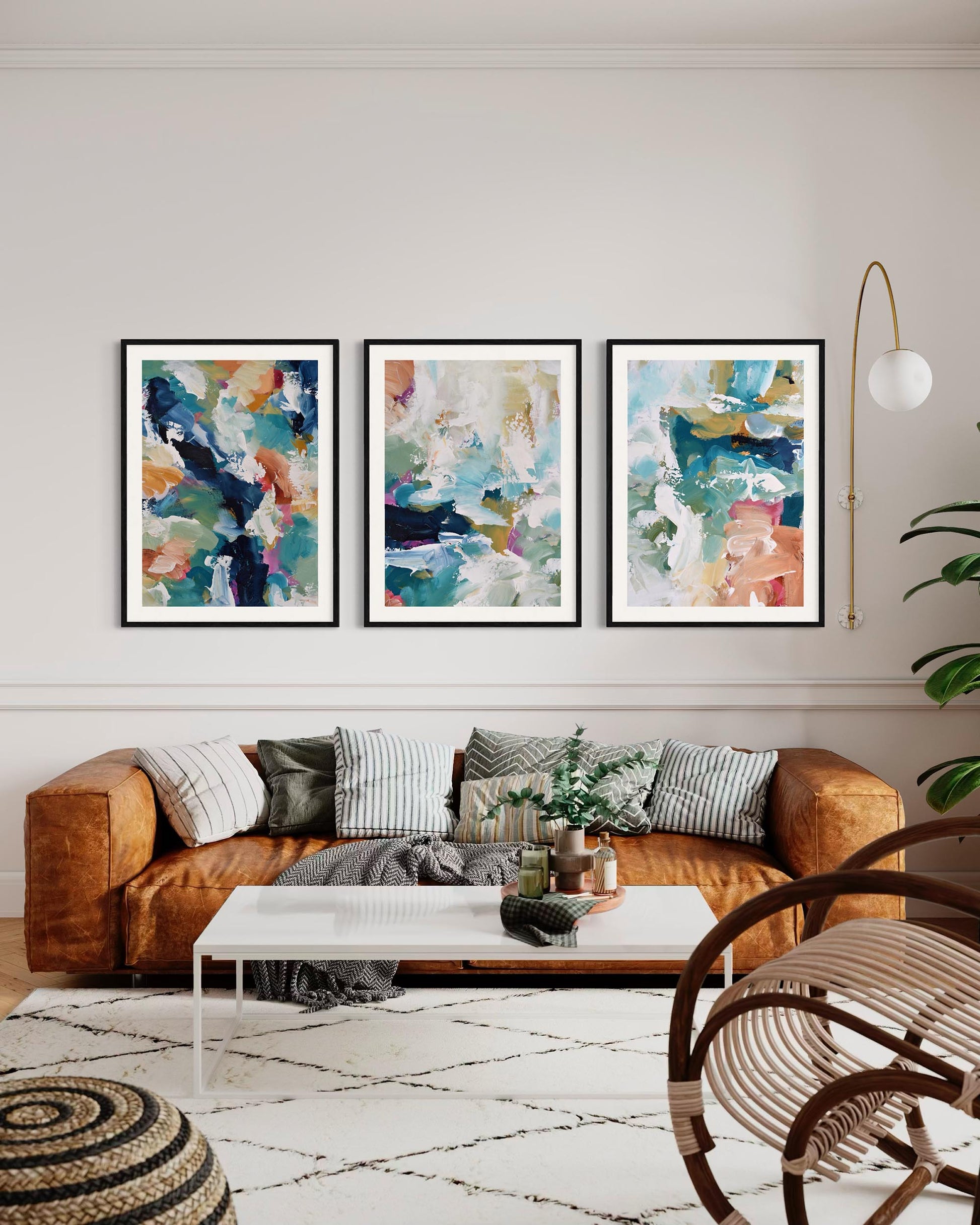 Living room with a brown sofa, abstract art on the wall, and a white coffee table.