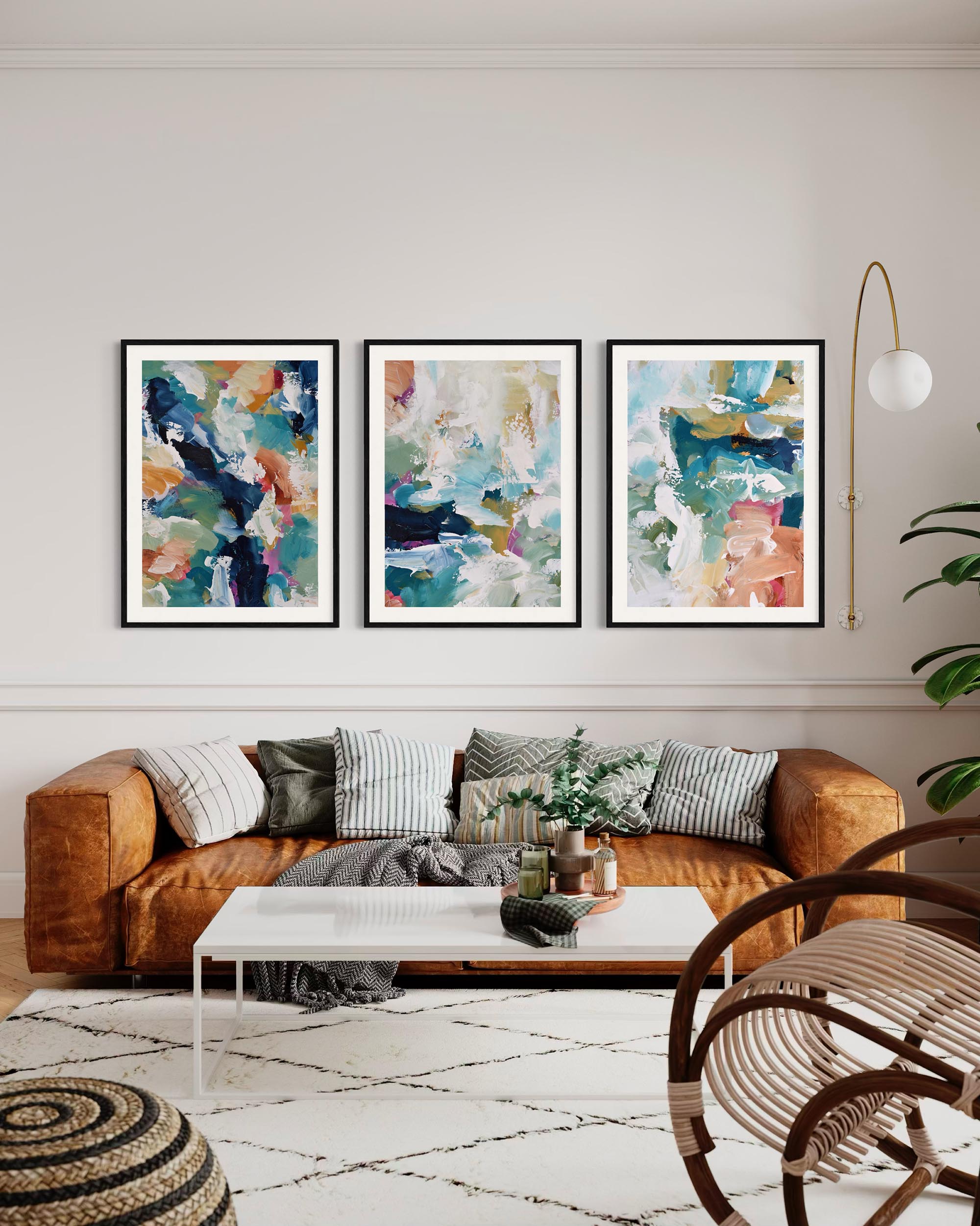 Living room with a brown sofa, abstract art on the wall, and a white coffee table.