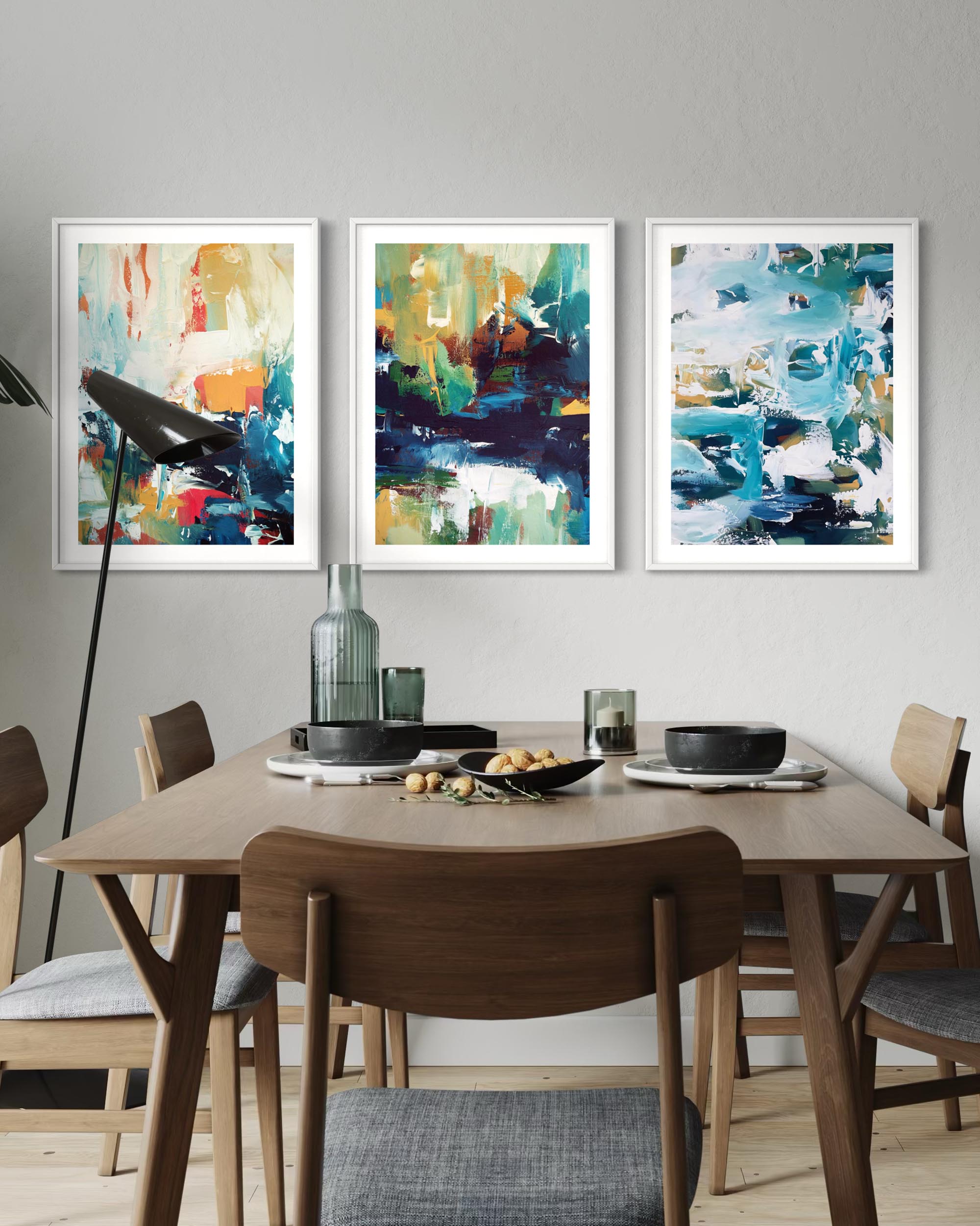 Dining room with abstract art on the wall and a table set for a meal.