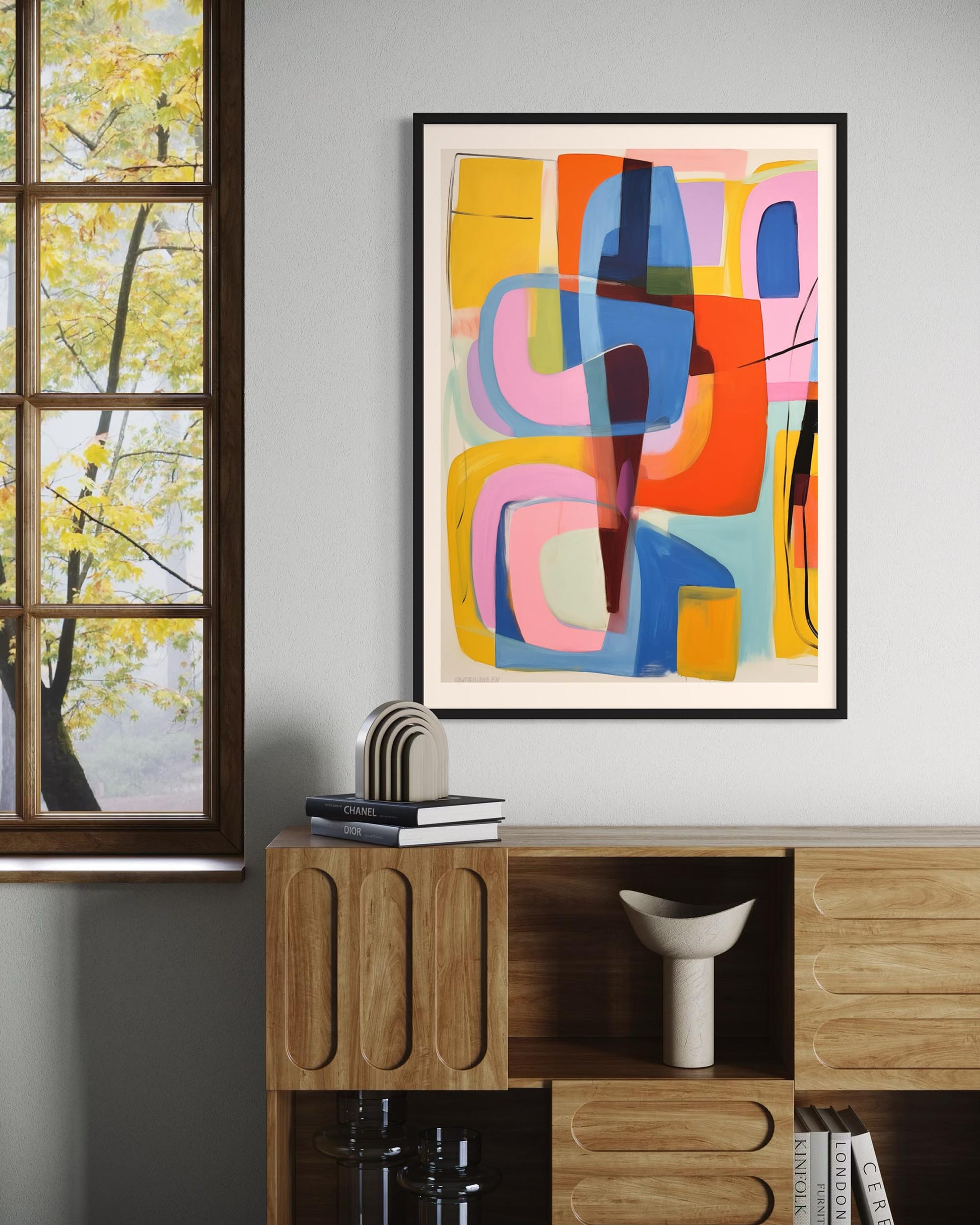 Colorful abstract art on a wall with a wooden cabinet and window in the background