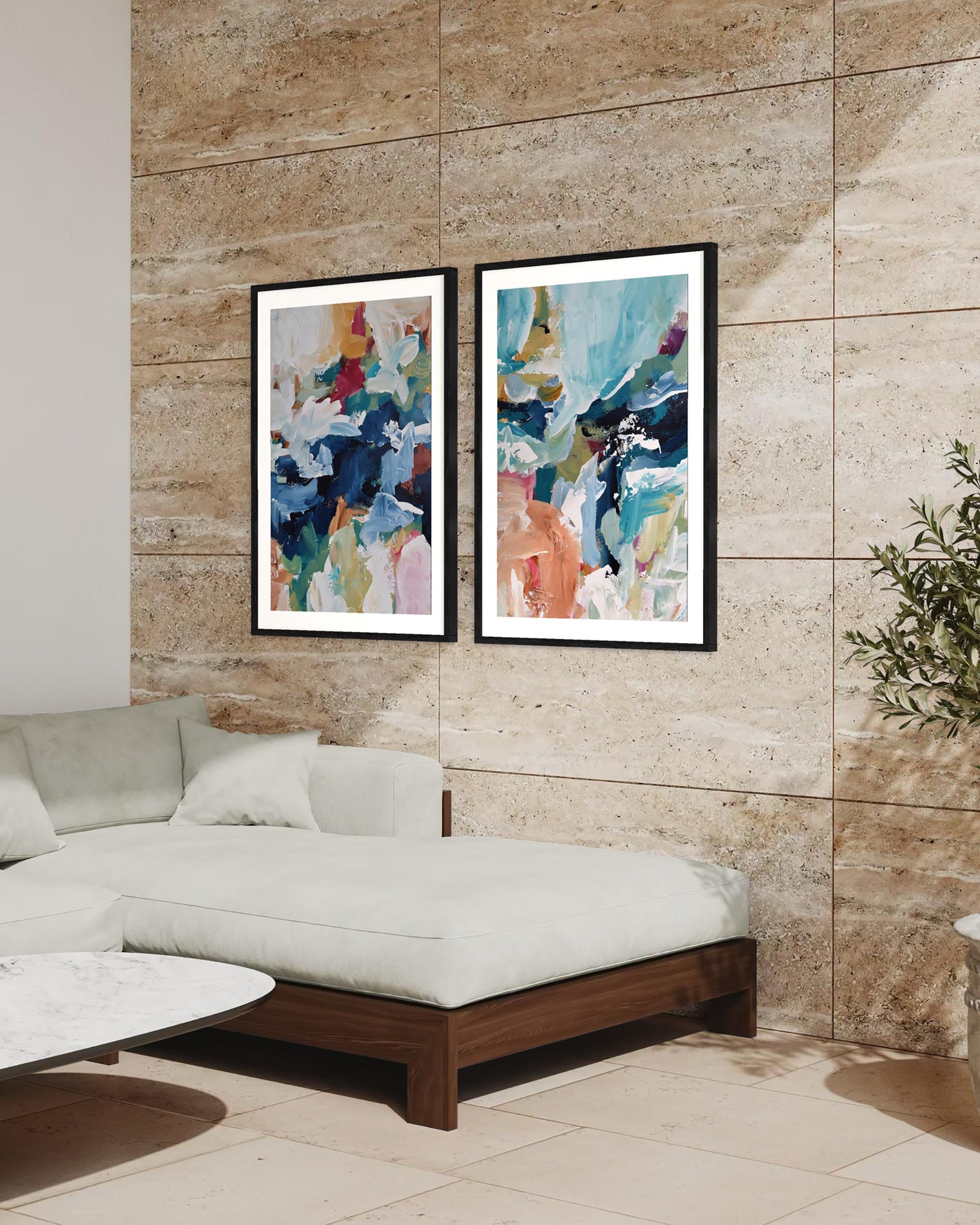Two abstract paintings on a wall above a sofa in a living room.