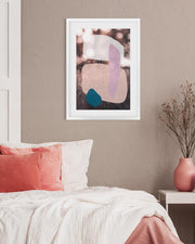 Abstract art print on a wall above a bed with pink and white bedding.
