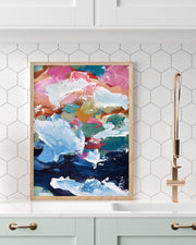 Colorful abstract painting in a wooden frame on a white wall with hexagonal tiles.