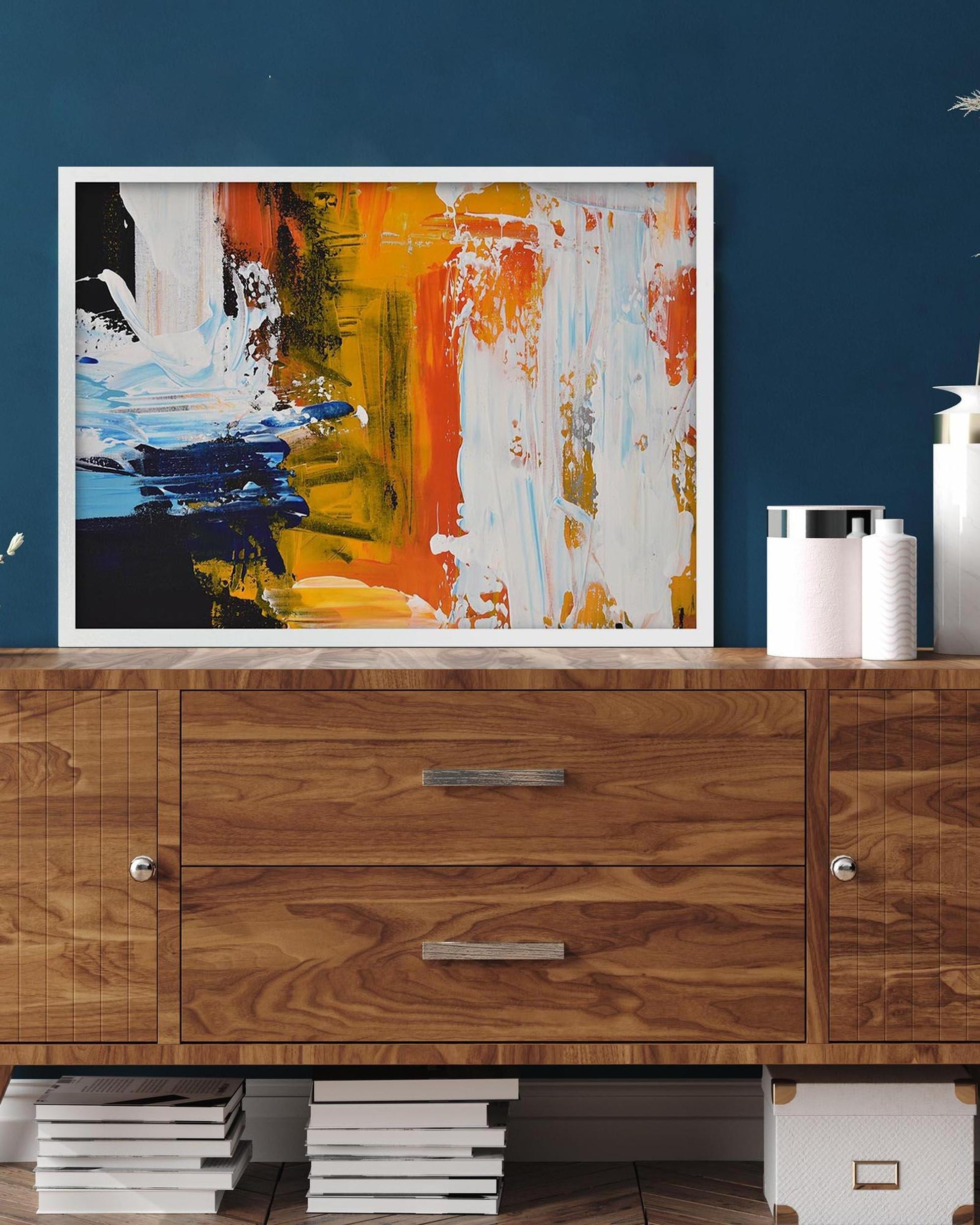 Abstract painting on a wooden cabinet against a blue wall