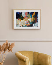 Framed abstract painting on a wall above a yellow armchair