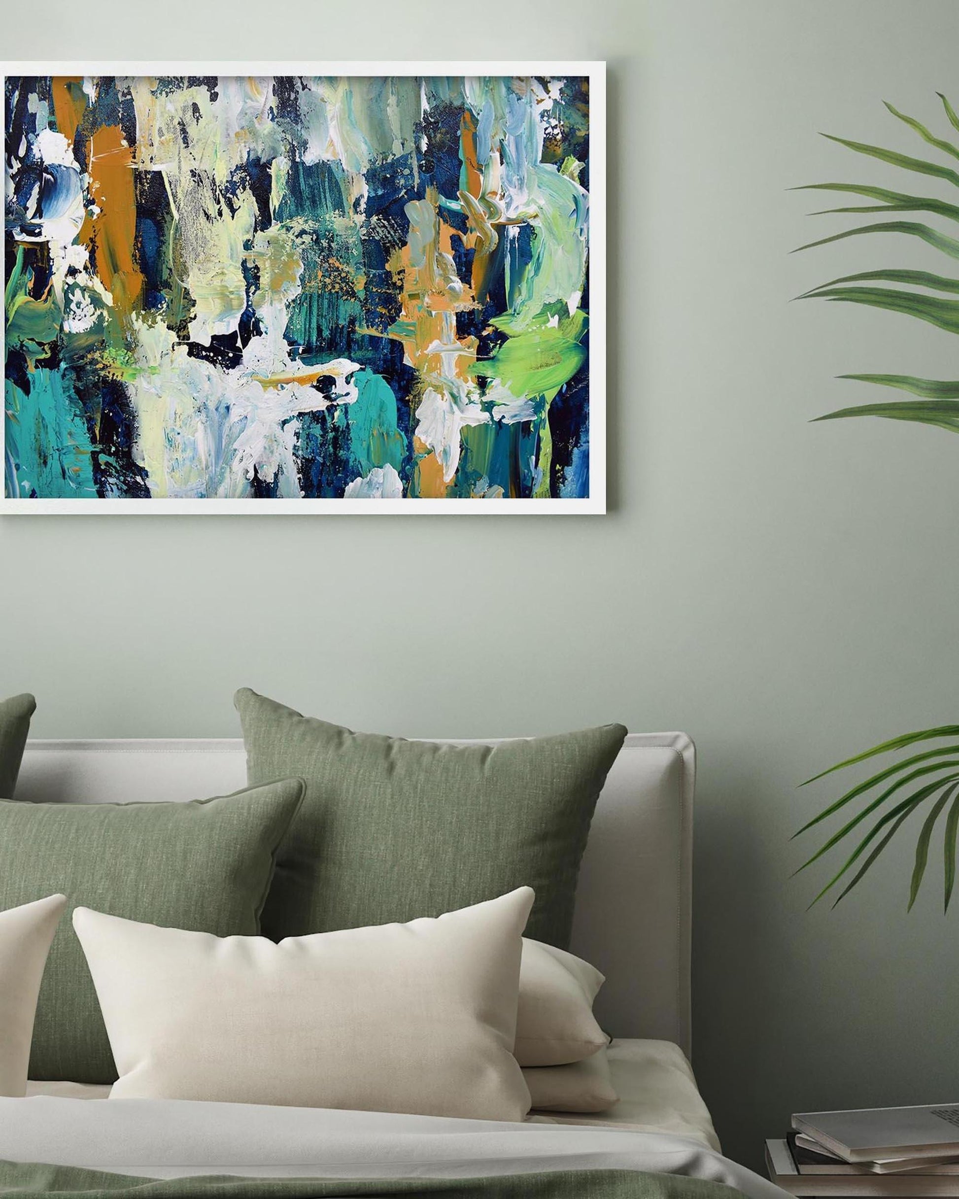 Abstract painting on a wall above a sofa with green and white cushions.