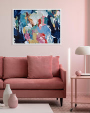 Living room with a pink sofa, abstract painting, and decorative items.