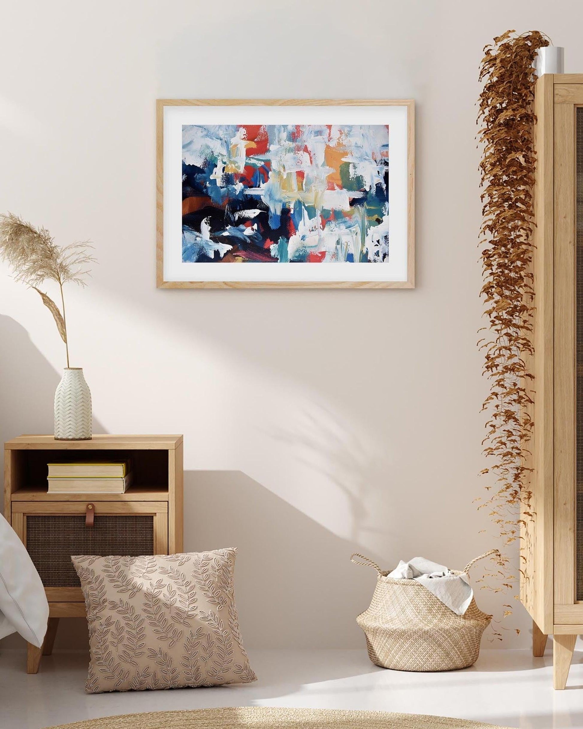Modern interior with abstract art on the wall, wooden side table, and decorative elements.
