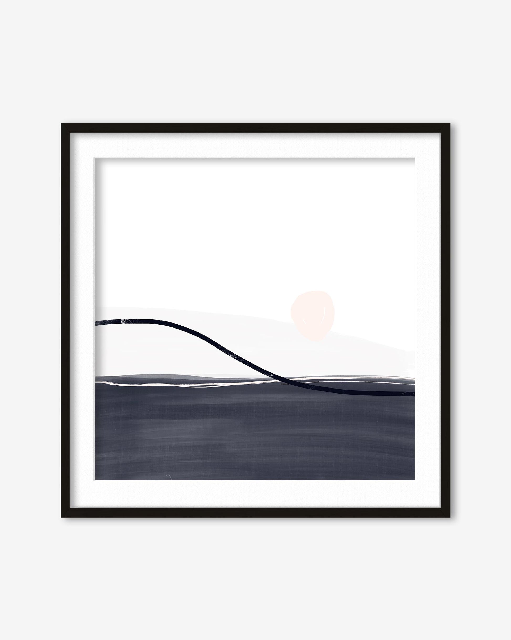 Framed abstract art print with a black frame on a white wall