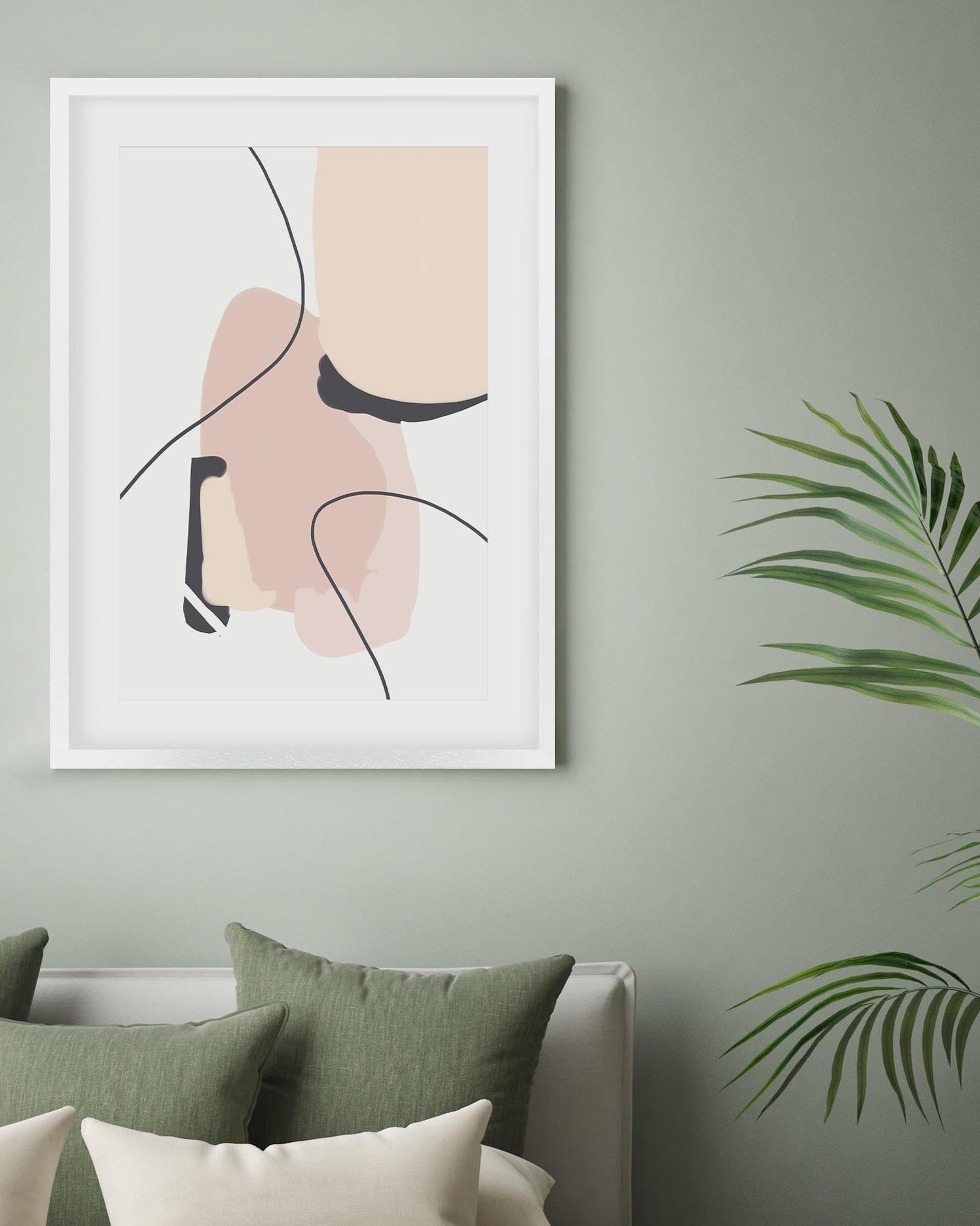 Framed abstract art print on a wall with greenery