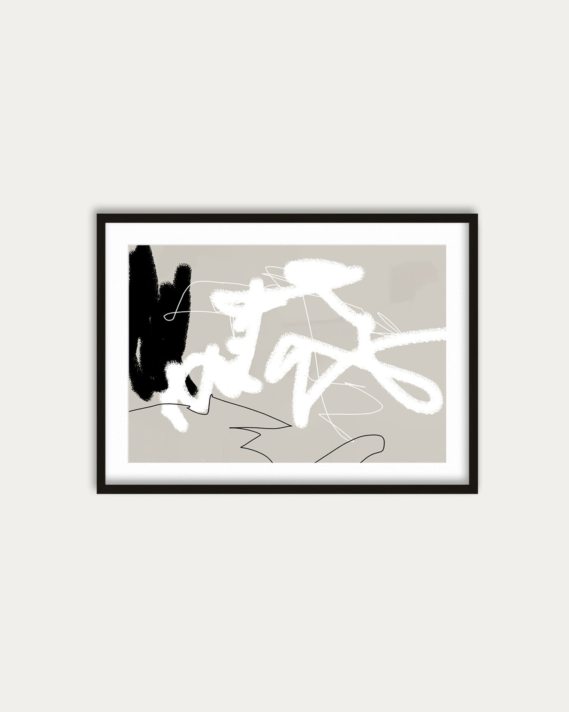 Framed abstract art print with black and white shapes on a beige background