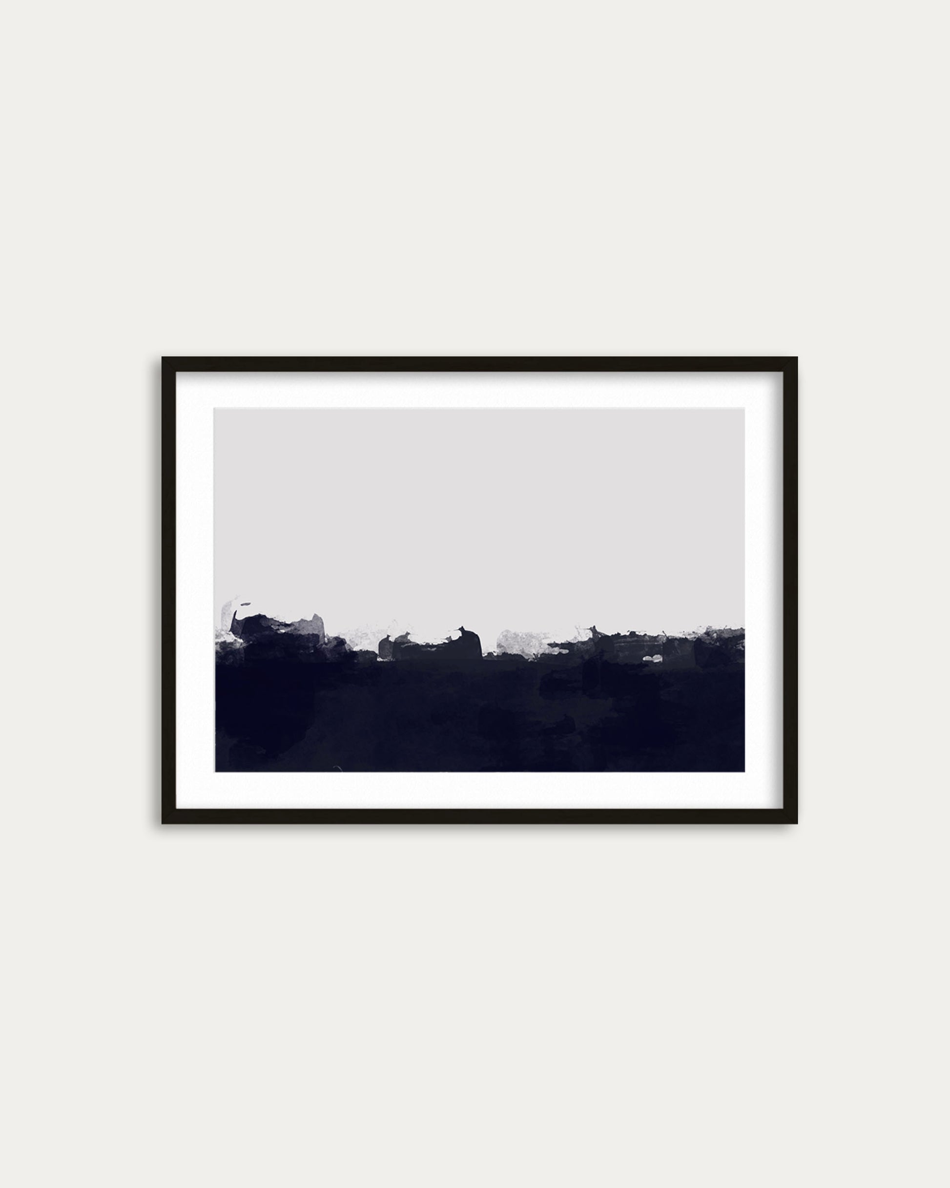 Framed black and white landscape print on a white wall