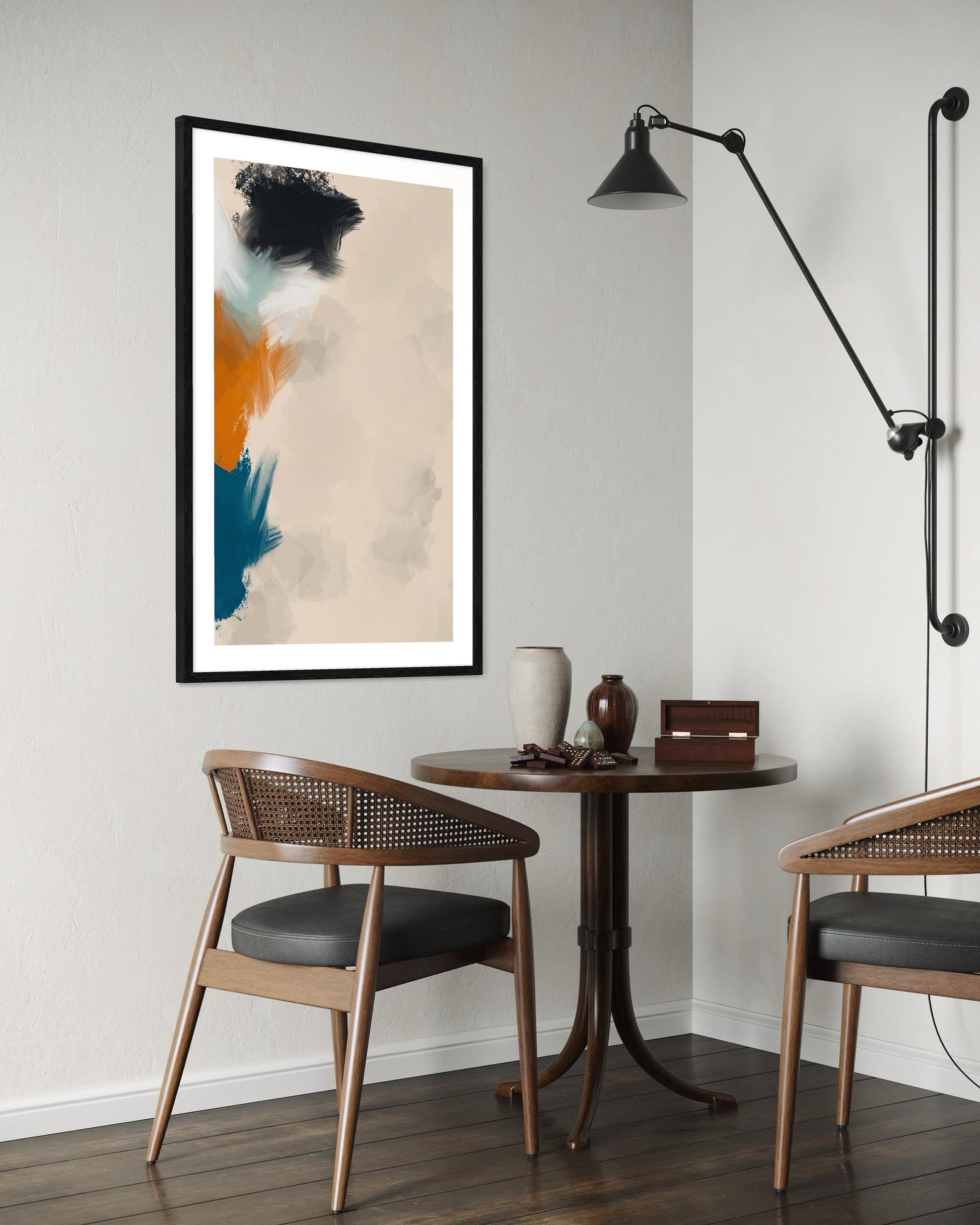 Modern interior with a small round table, chairs, and abstract art on the wall.
