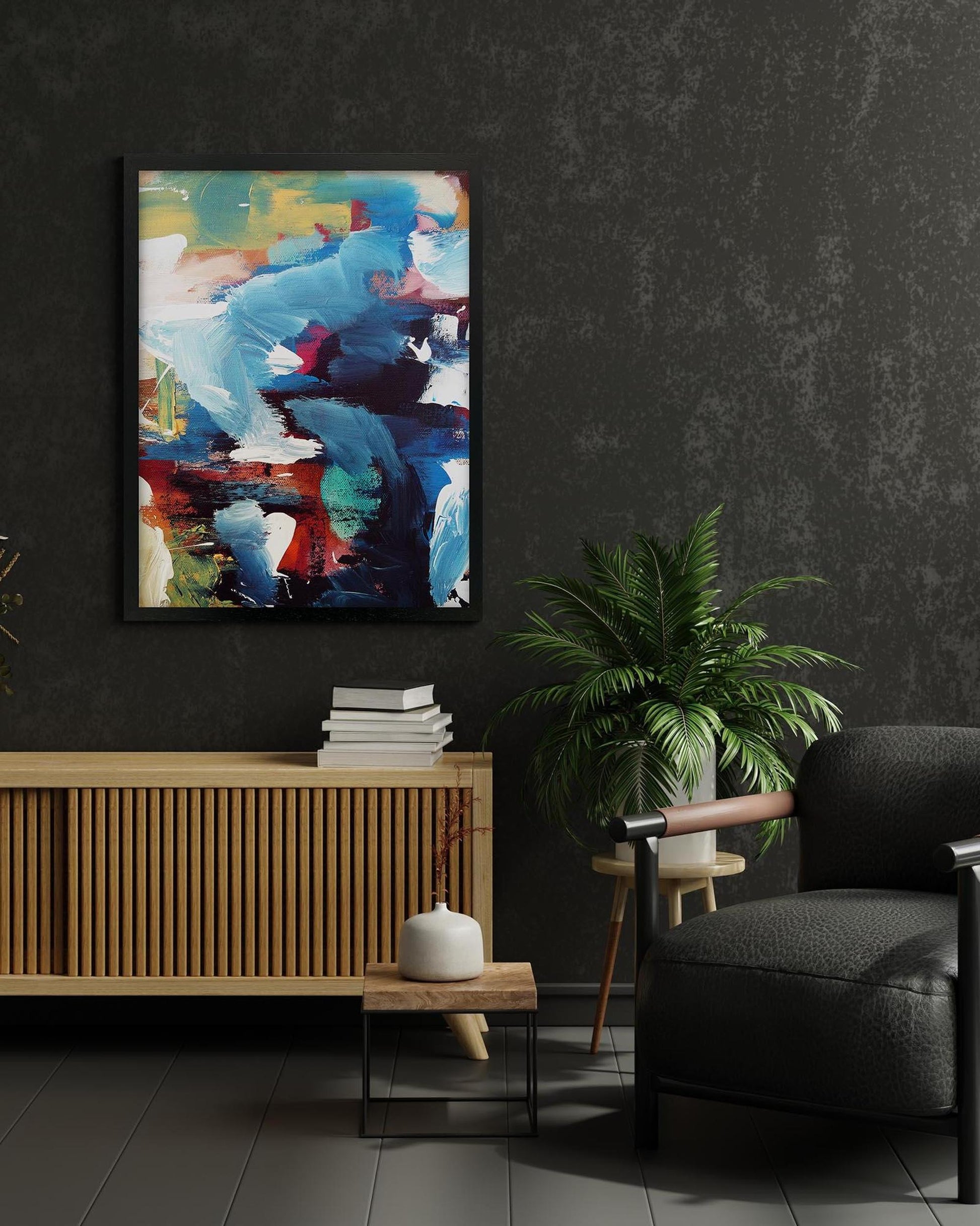 Modern interior with abstract art, plant, and furniture against a dark wall.