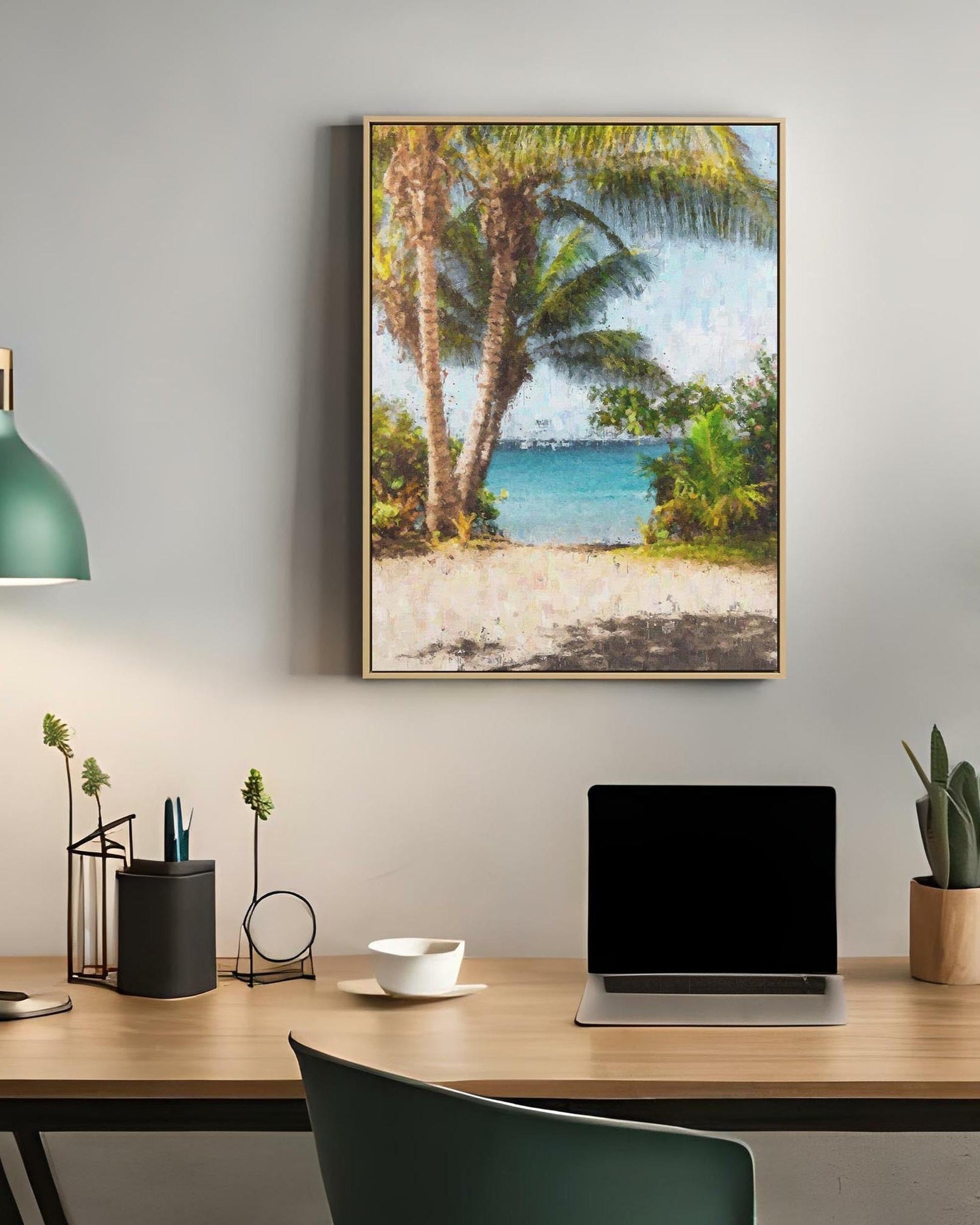 Modern office desk with laptop, lamp, and decorative items, featuring a tropical beach painting on the wall.