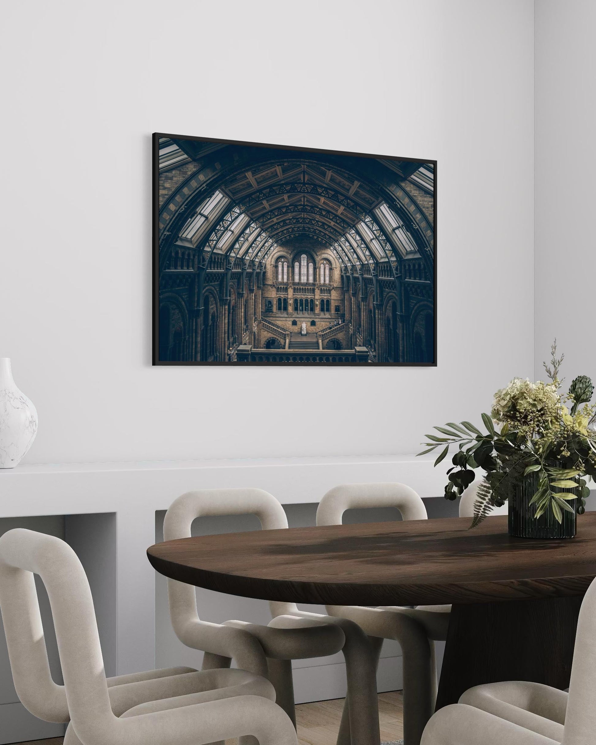 Dining room with a large framed photograph of a historic building on the wall.