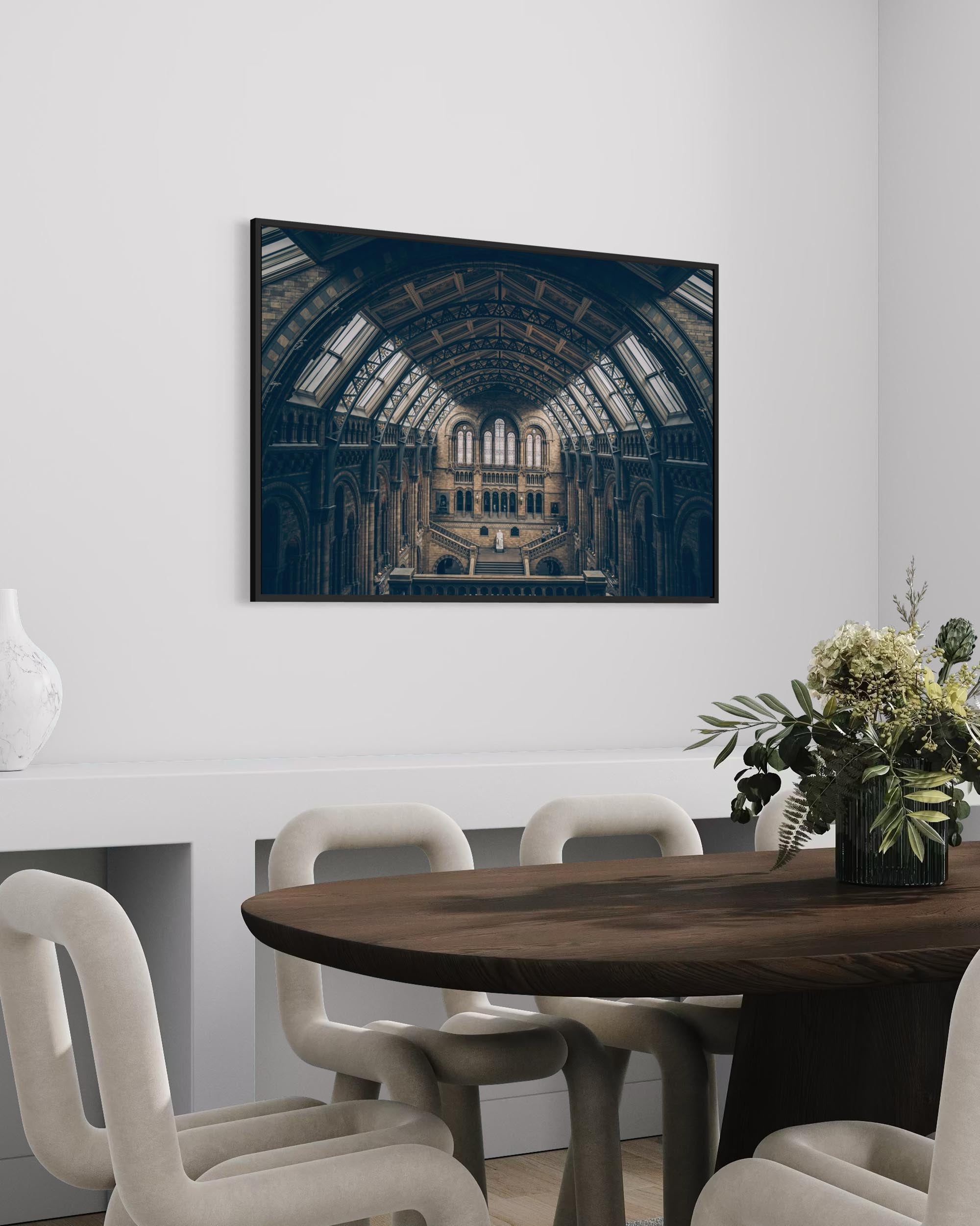 Dining room with a large framed photograph of a historic building on the wall.