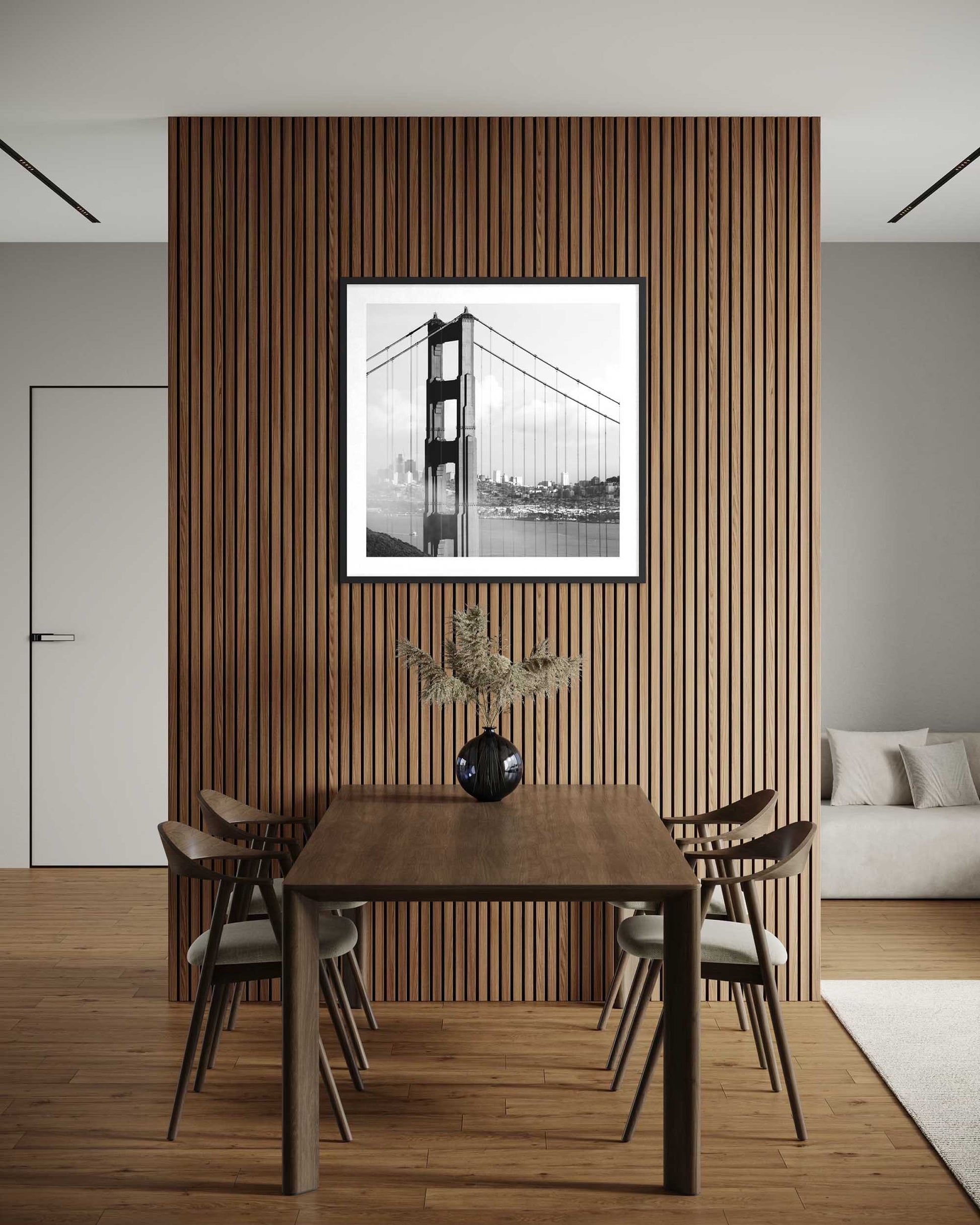 Dining room with wooden table and chairs, framed picture on slatted wall.