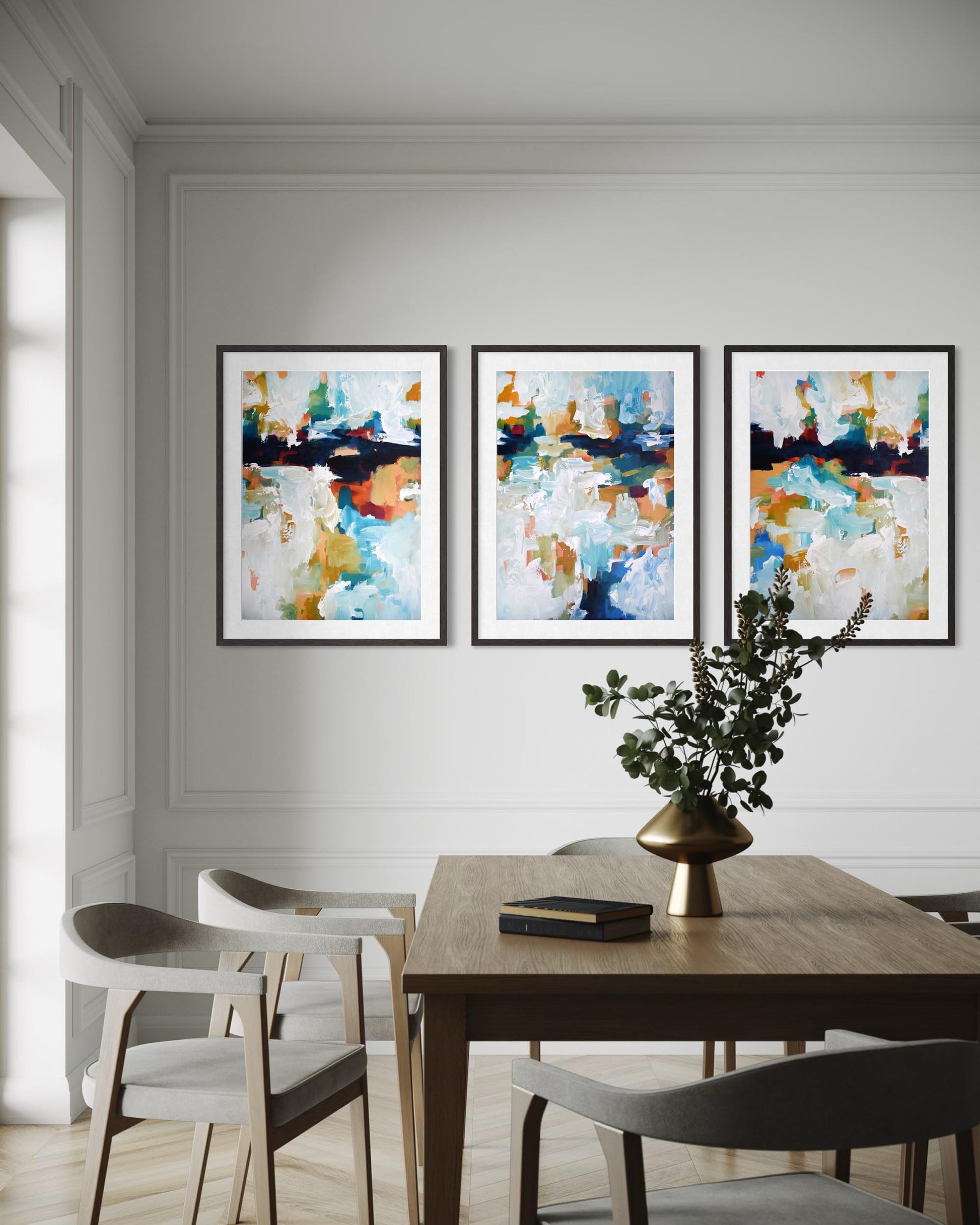 Dining room with abstract art on the wall and a table with decor items.