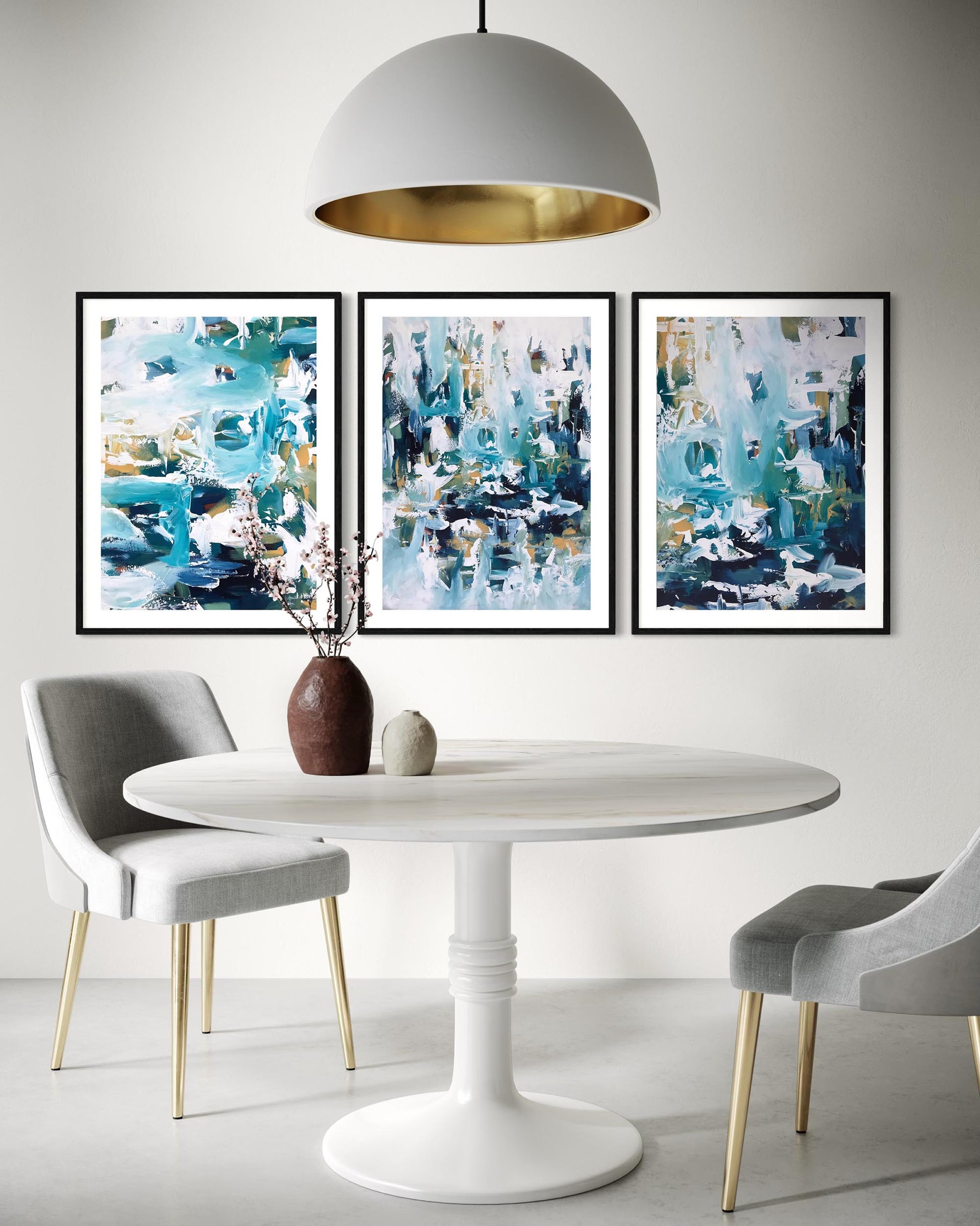 Dining room with a white table, gray chairs, and abstract art on the wall.