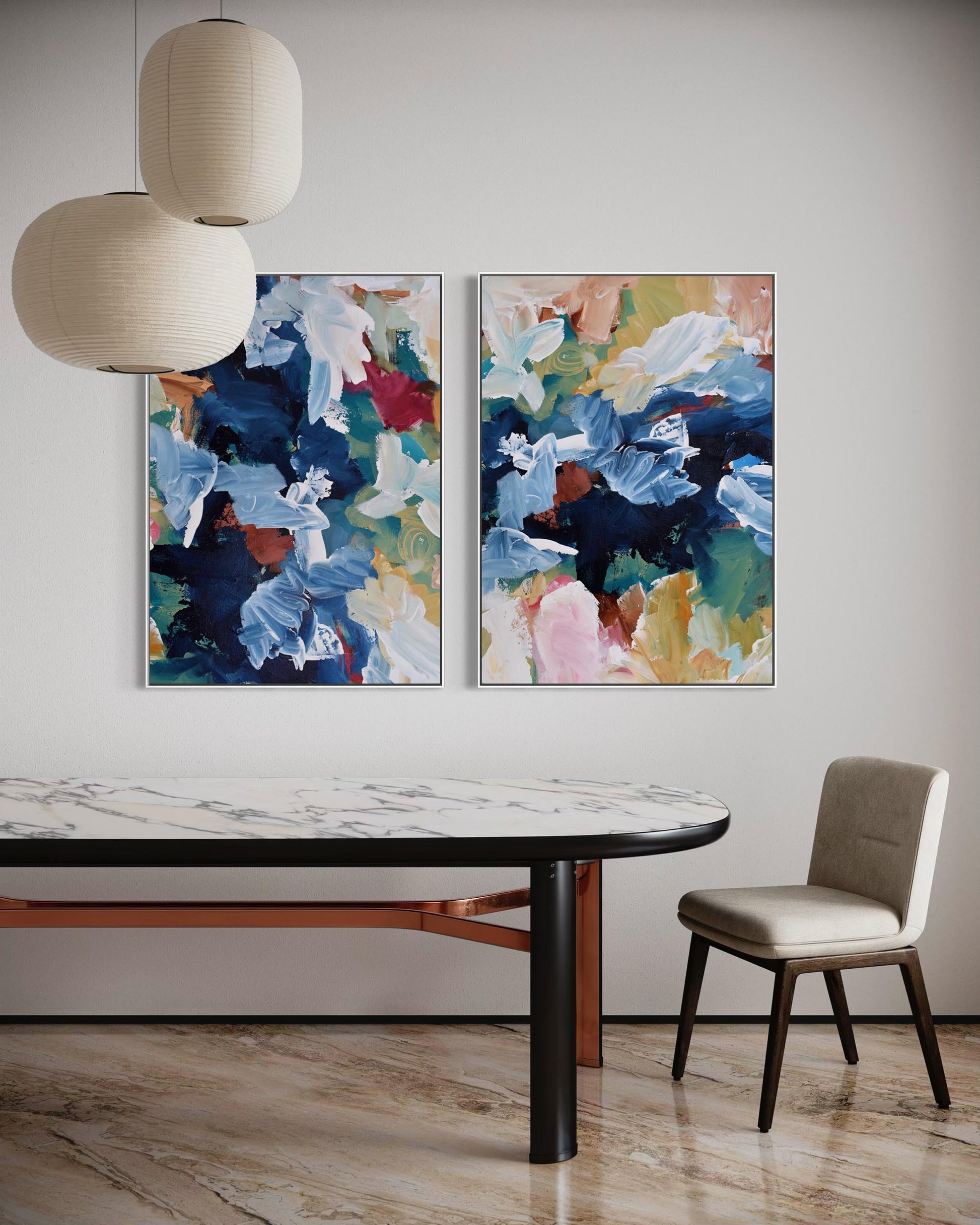 Dining room with abstract floral paintings on the wall, a marble table, and a chair.
