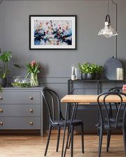 Dining room with a wooden table, black chairs, and a gray wall with abstract art.