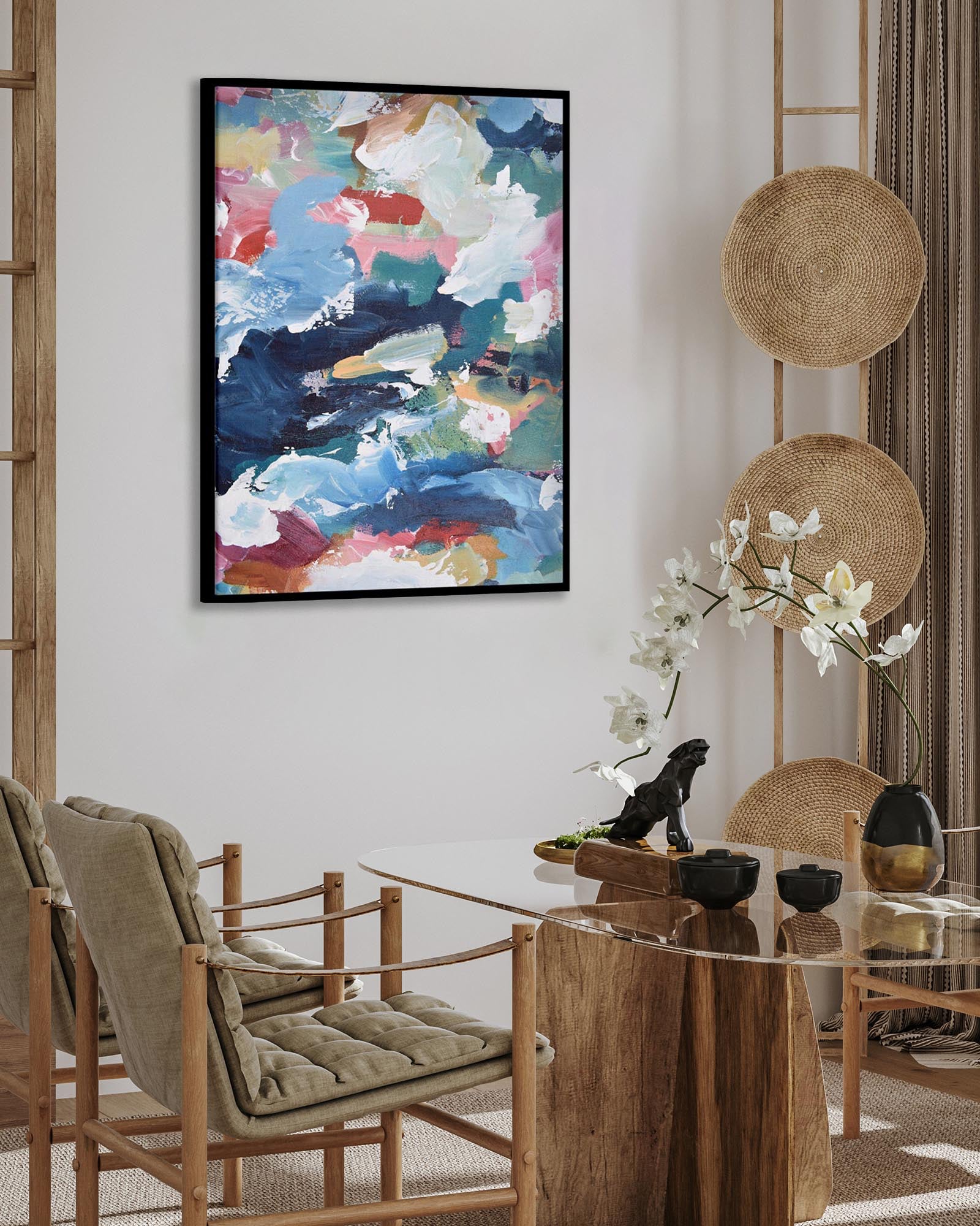 Dining room with a round wooden table, chairs, and abstract art on the wall.