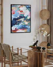 Dining room with a round wooden table, chairs, and abstract art on the wall.