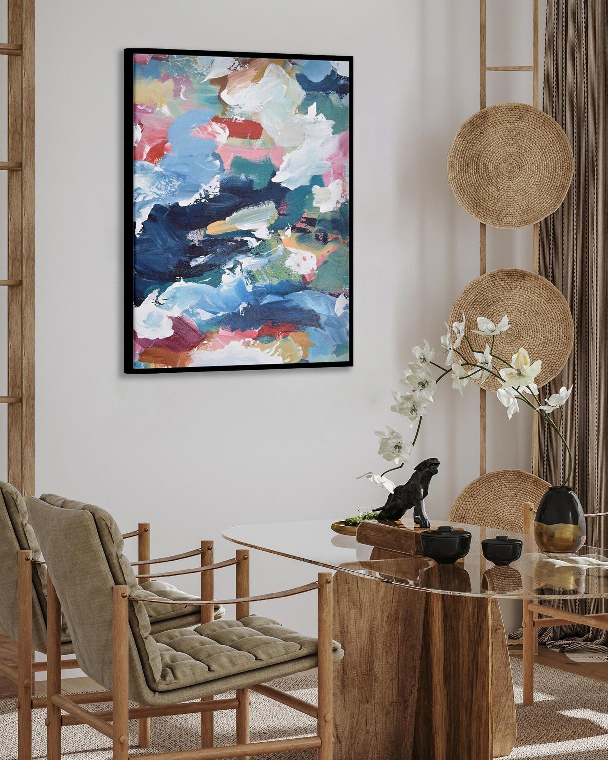 Dining room with a round wooden table, chairs, and abstract art on the wall.