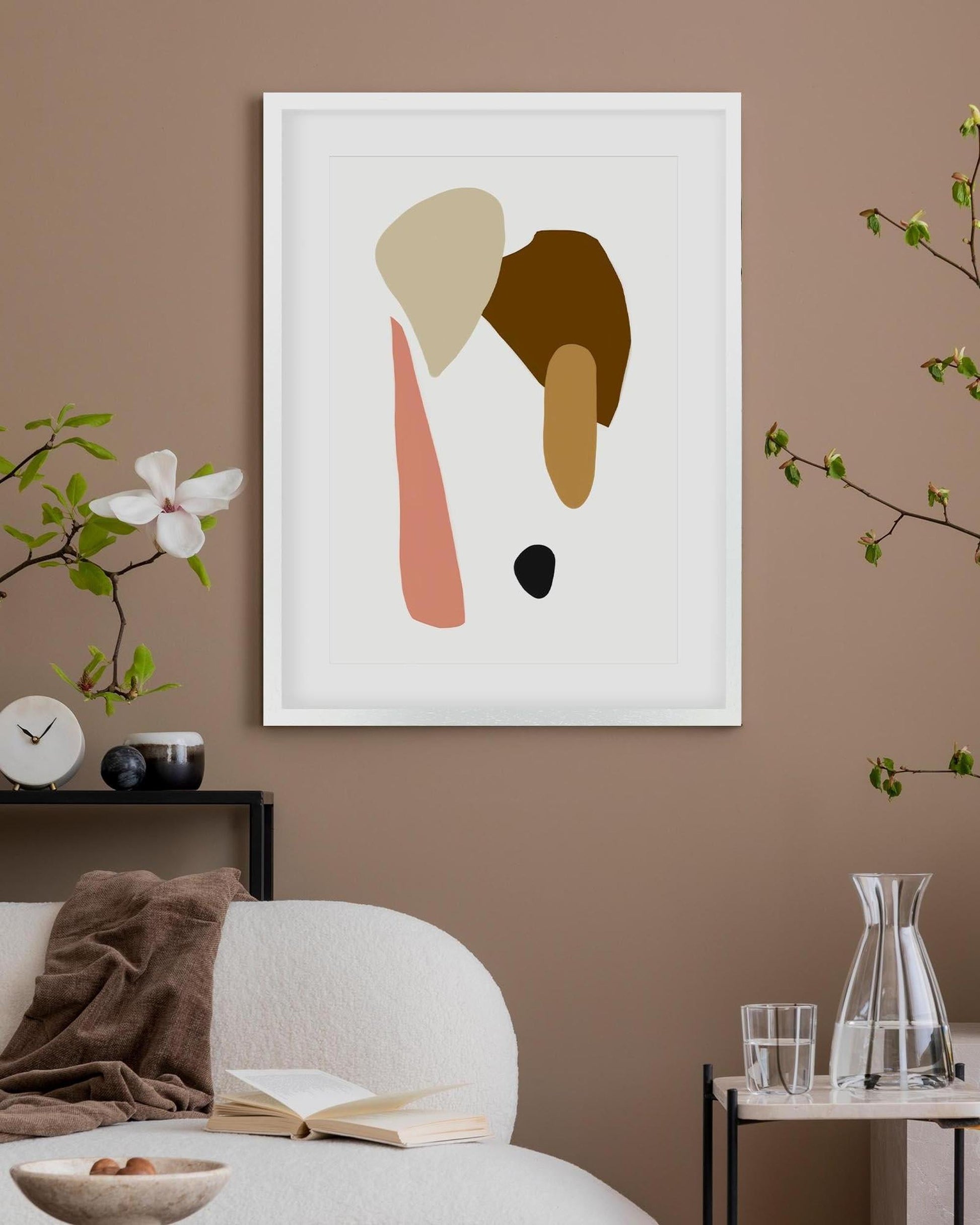 Abstract art print on a wall in a living room setting with decor elements.