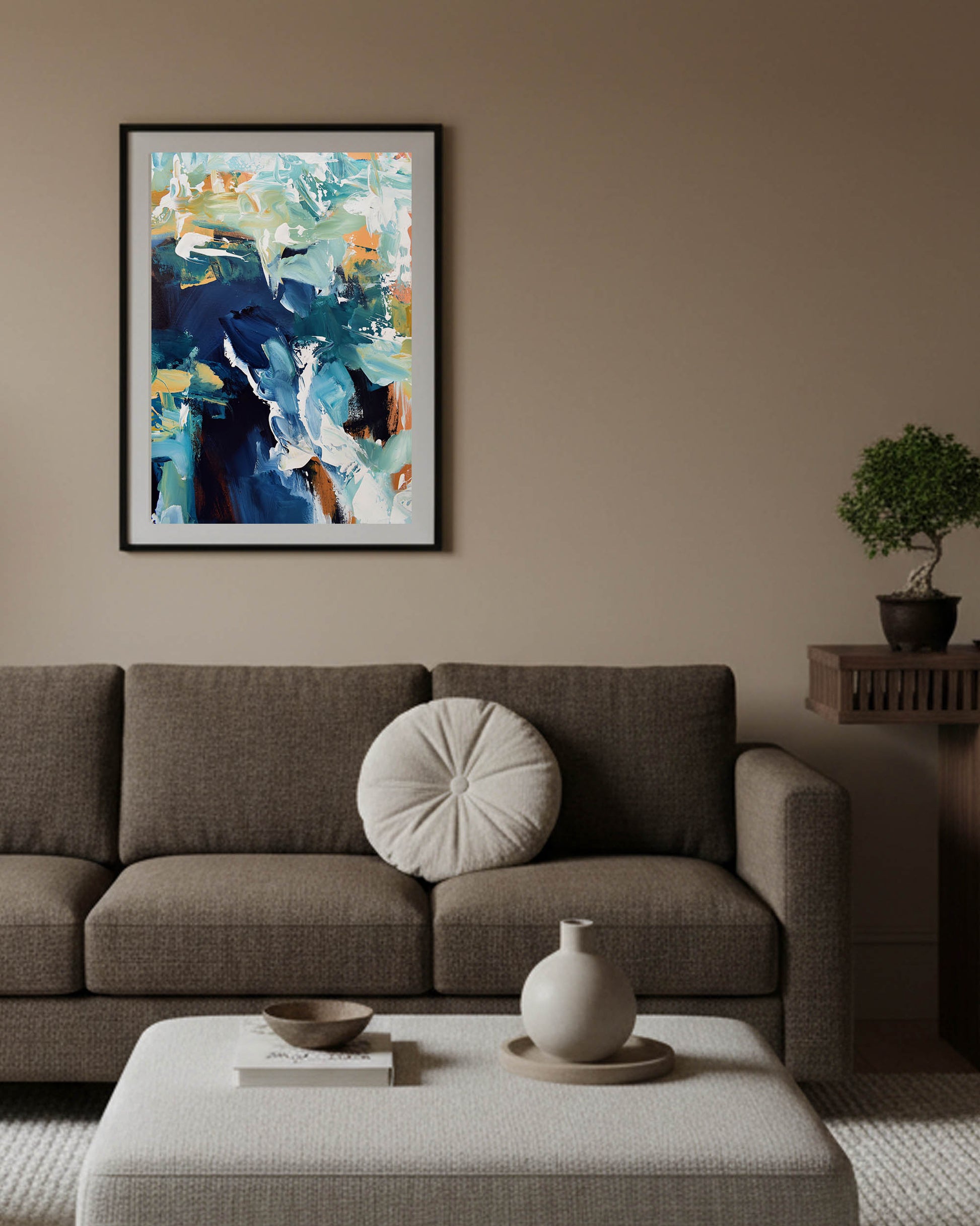 Living room with a brown sofa, abstract painting on the wall, and decorative items.