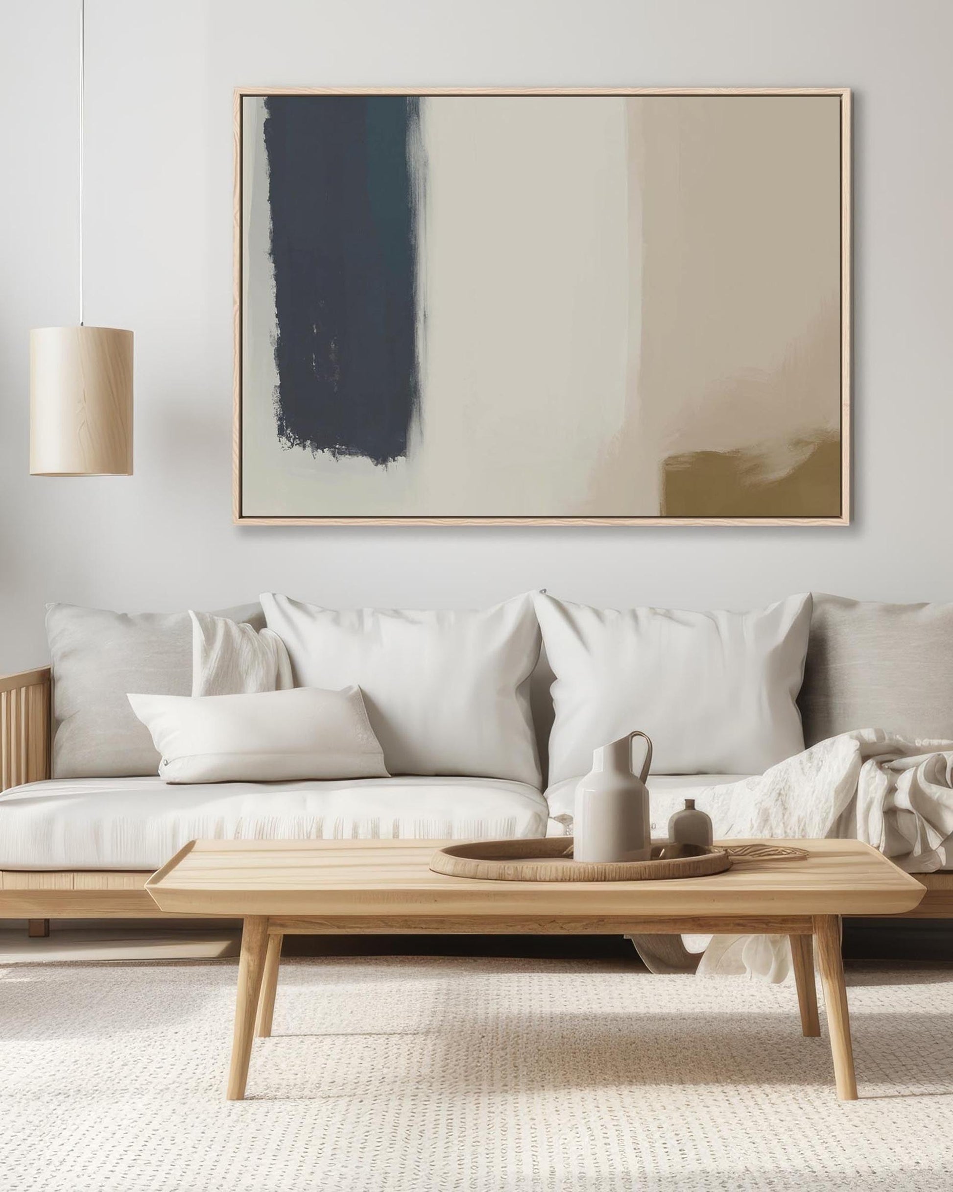 Modern living room with a white sofa, wooden coffee table, and abstract painting on the wall.