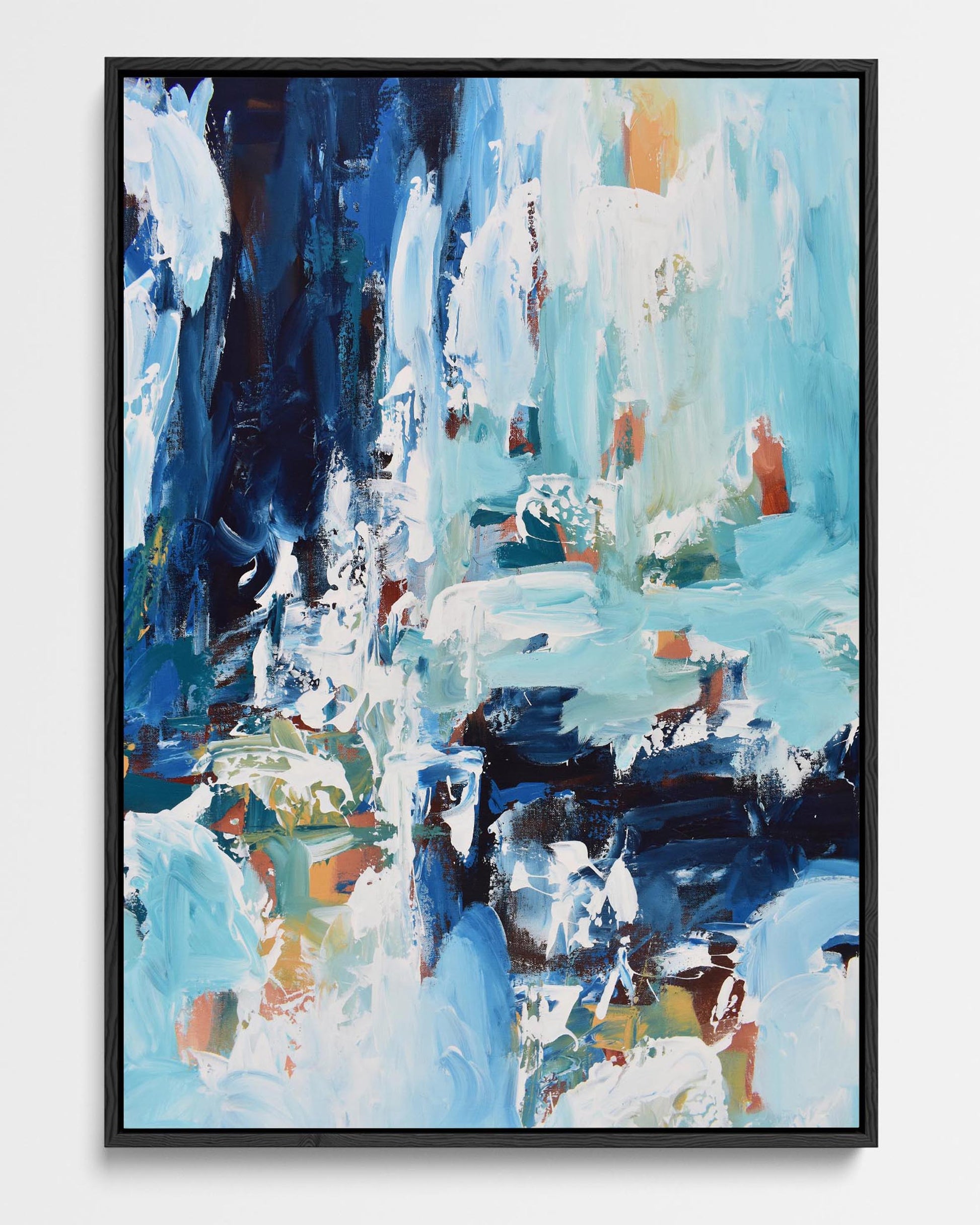 A framed canvas featuring an abstract design with modern blues, yellow, green, and red tones.