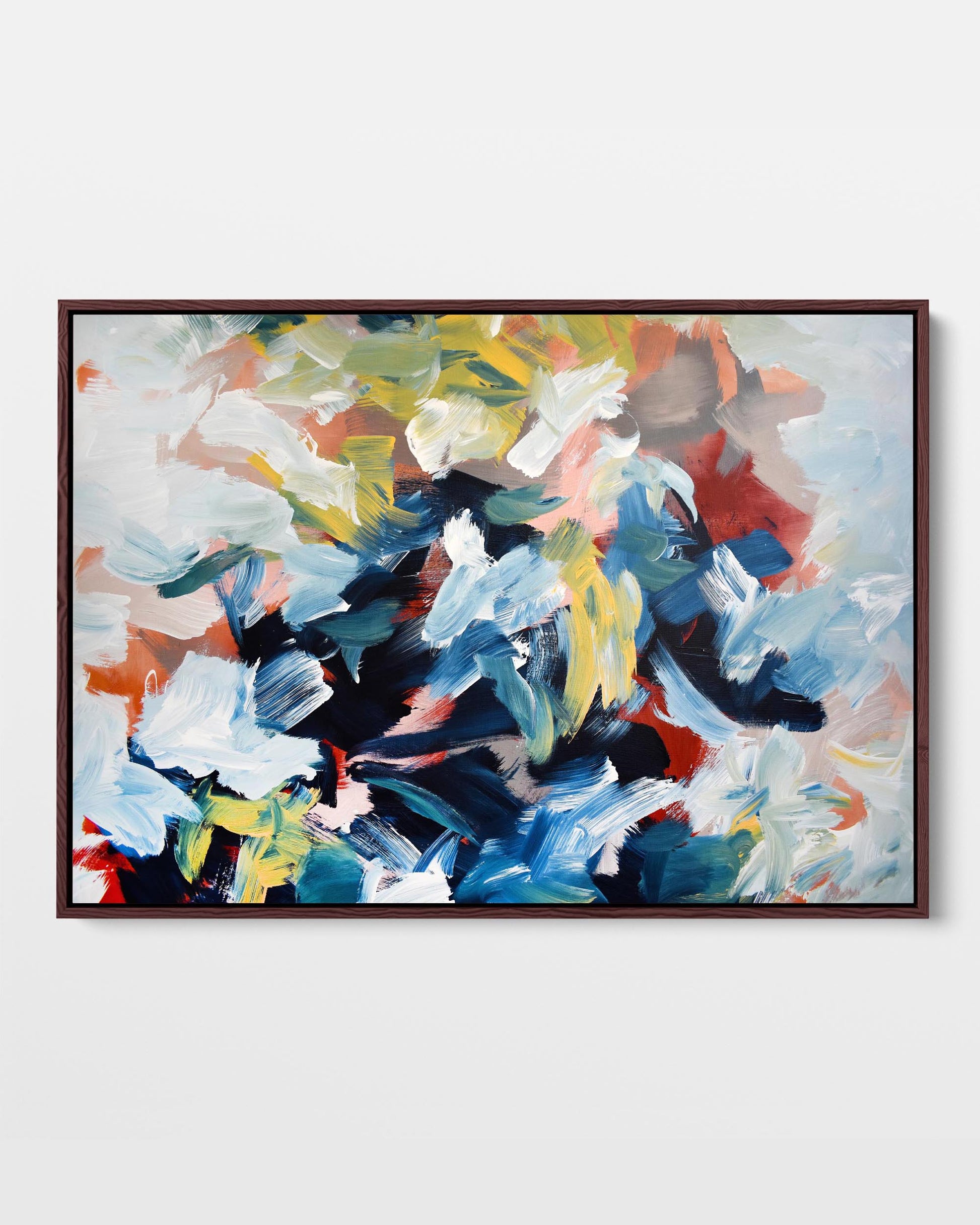A vibrant abstract canvas print with a combination of blue, yellow, green, and red tones, framed in either black or white.