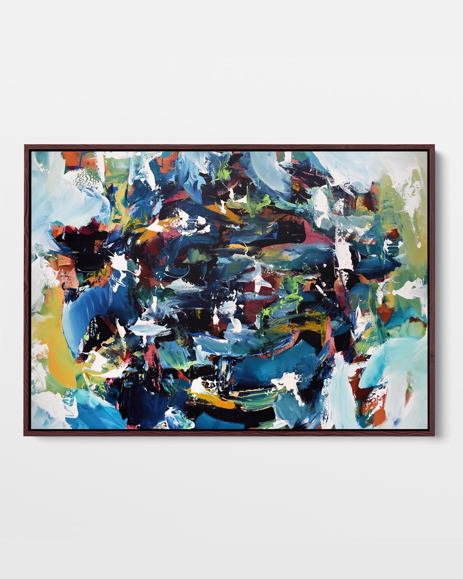 A framed canvas with an abstract design featuring modern blue, brown, purple, green, and orange tones, displayed against a plain background.