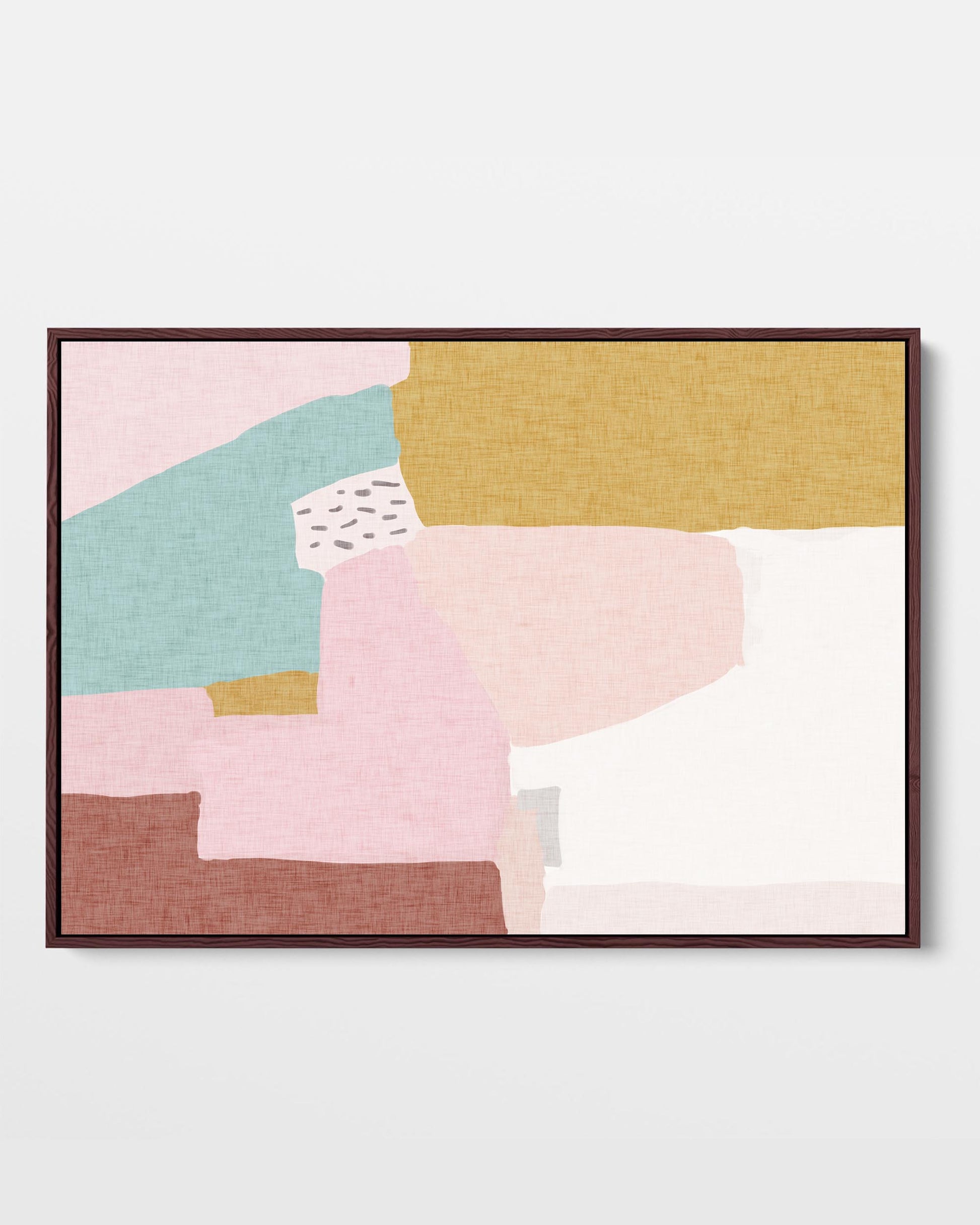 A framed canvas featuring an abstract design with blocks of pastel pink, green, and ochre colors.