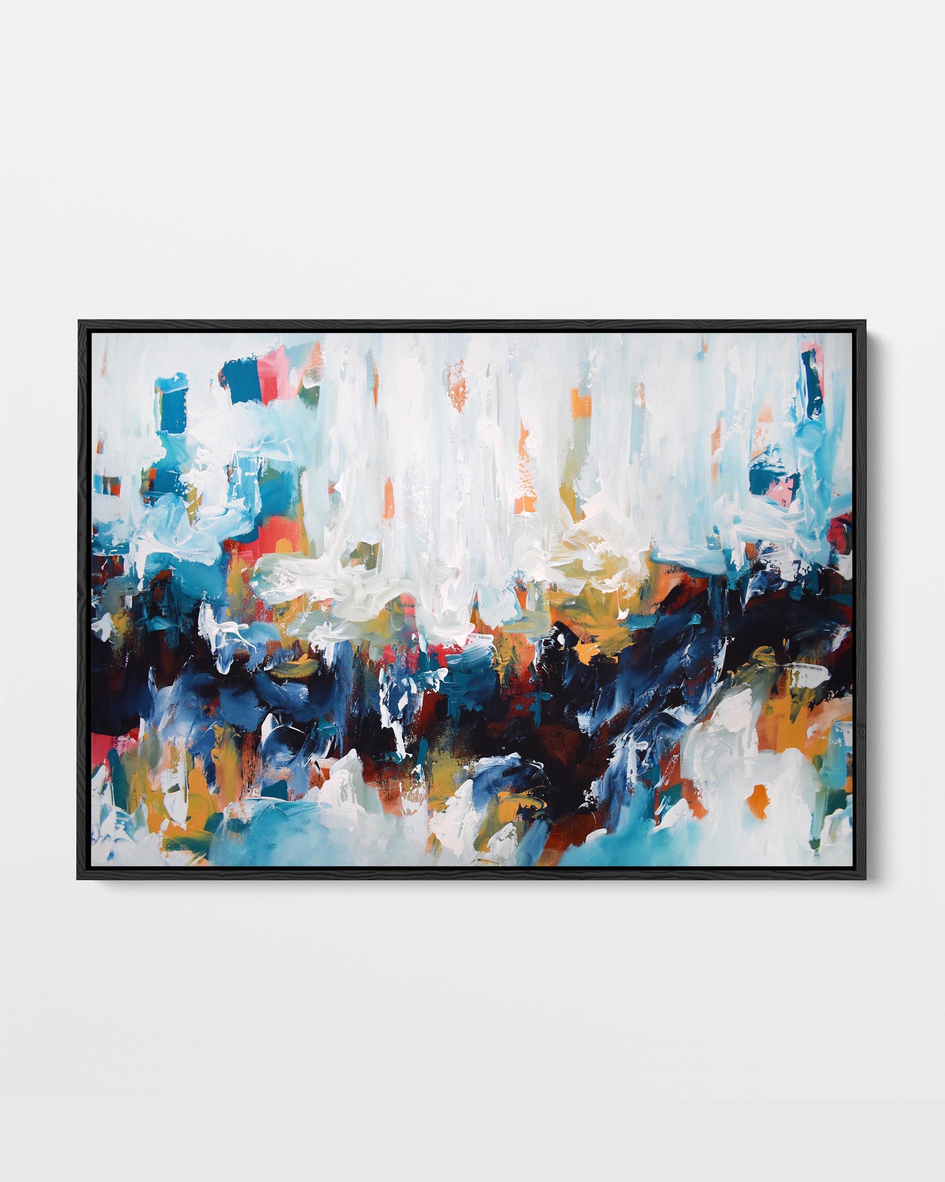 A framed canvas with an abstract design featuring modern blue, white, and orange tones, presented in a black frame.