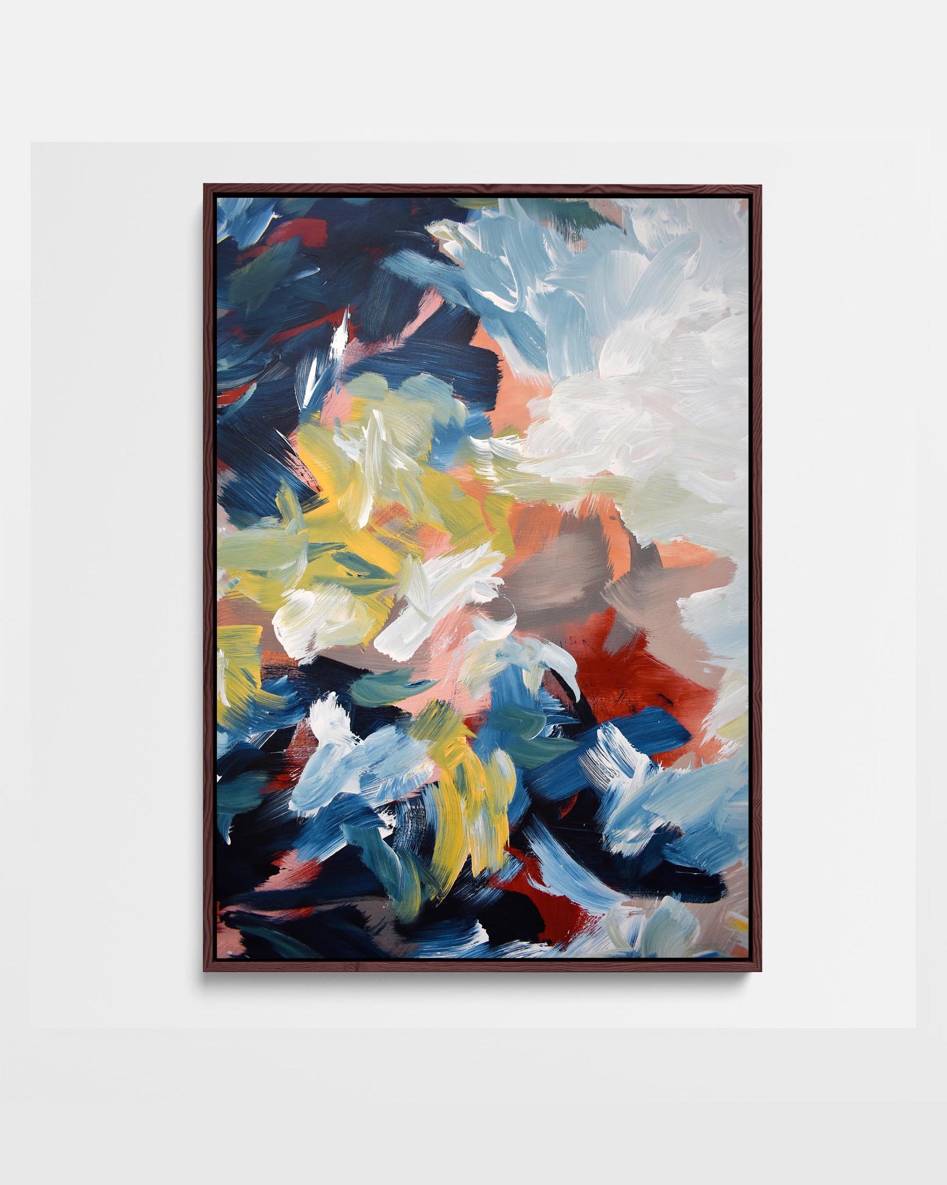 A framed canvas featuring an abstract design with modern blue, yellow, green, and red tones.