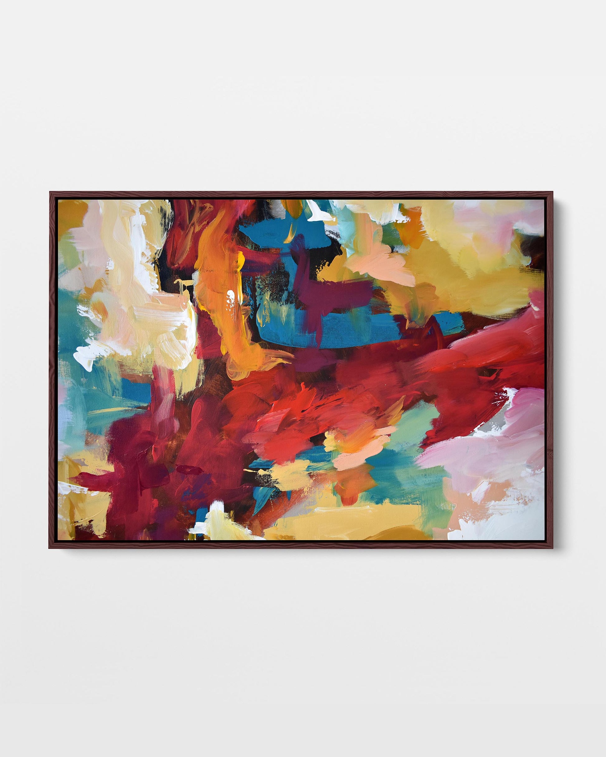 A framed canvas featuring an abstract painting with bold colors including blue, red, yellow, and pink.
