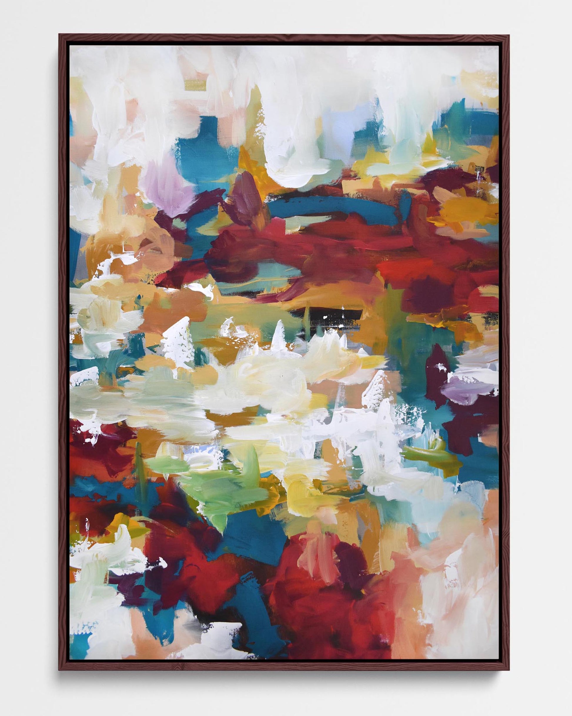 A framed canvas featuring an abstract design with vibrant colors including red, orange, white, green, and blue.
