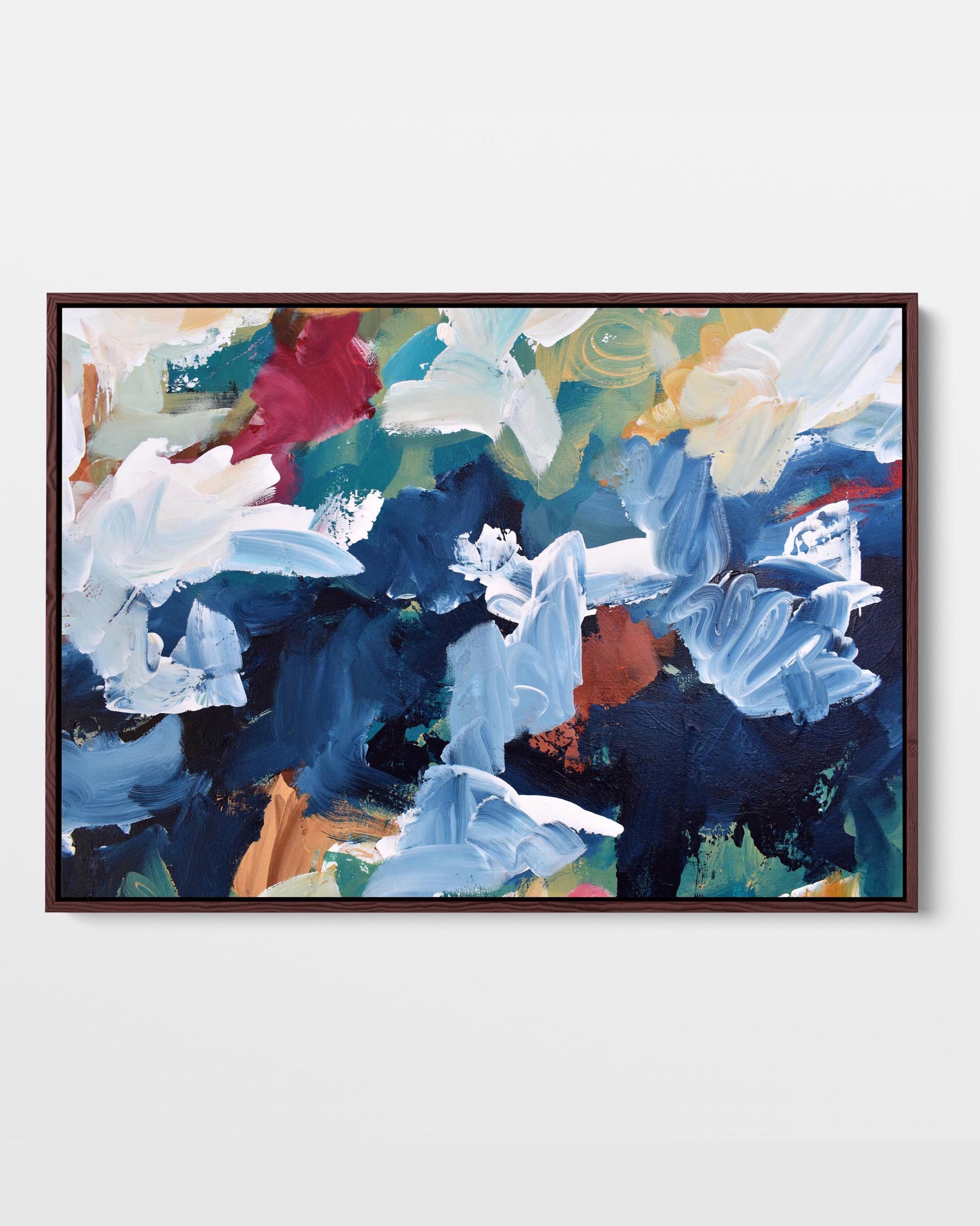 A vibrant abstract canvas print with a combination of blue, white, dark navy, and brown tones, framed in either black or white.