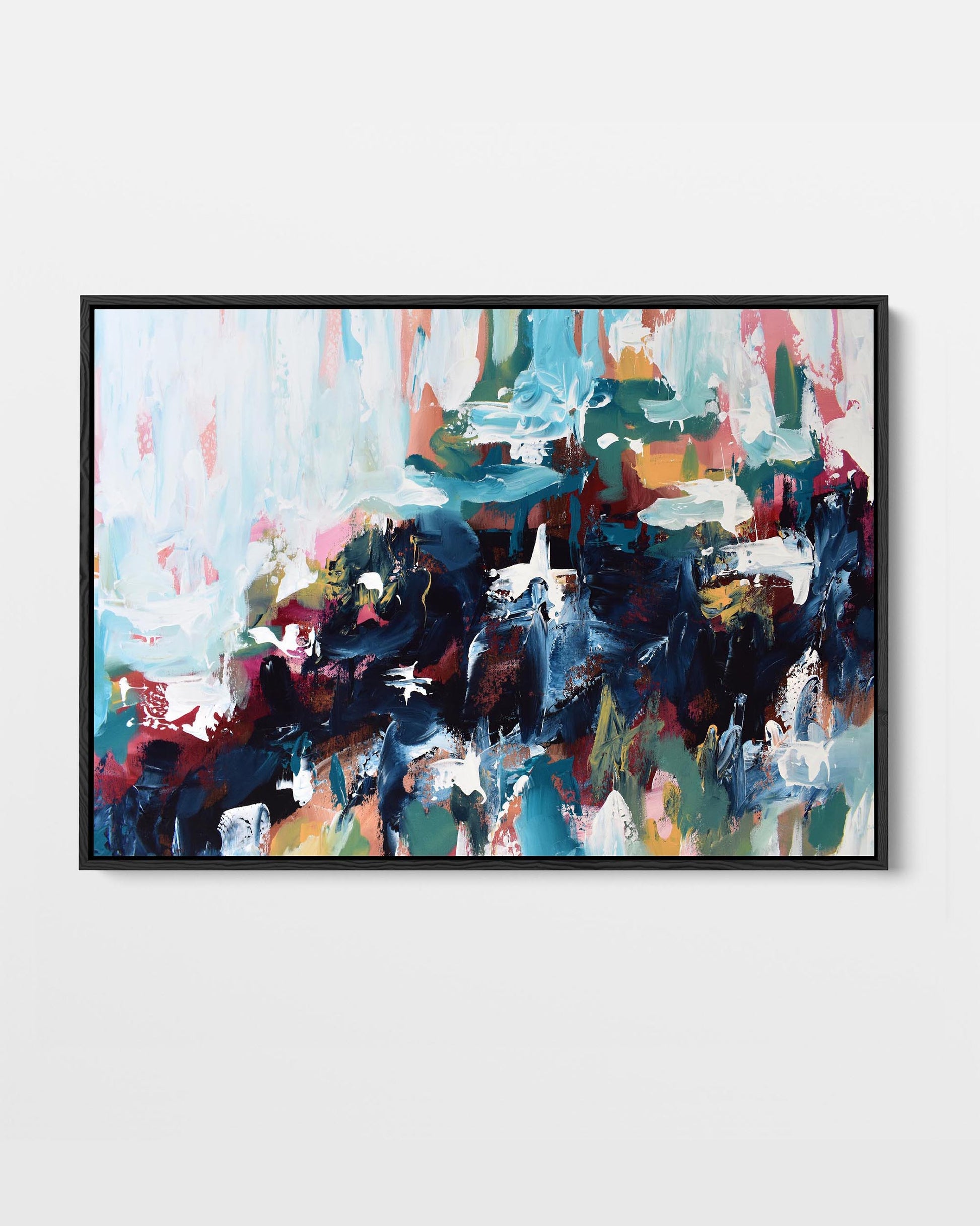 A vibrant abstract canvas print with blue, yellow, green, pink, and red tones, framed in either black or white.